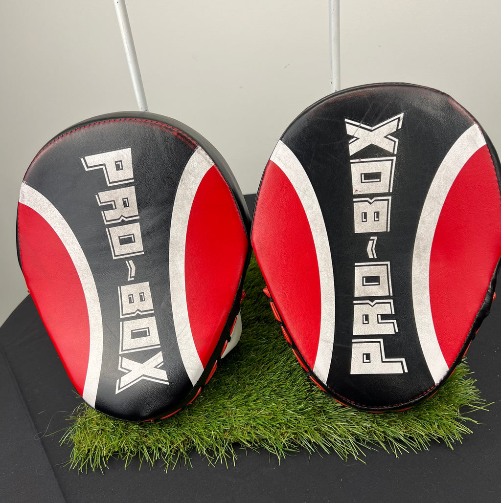 Top view of Pro-Box curved sparring pads showing black, red and white padded striking surfaces with Pro-Box branding