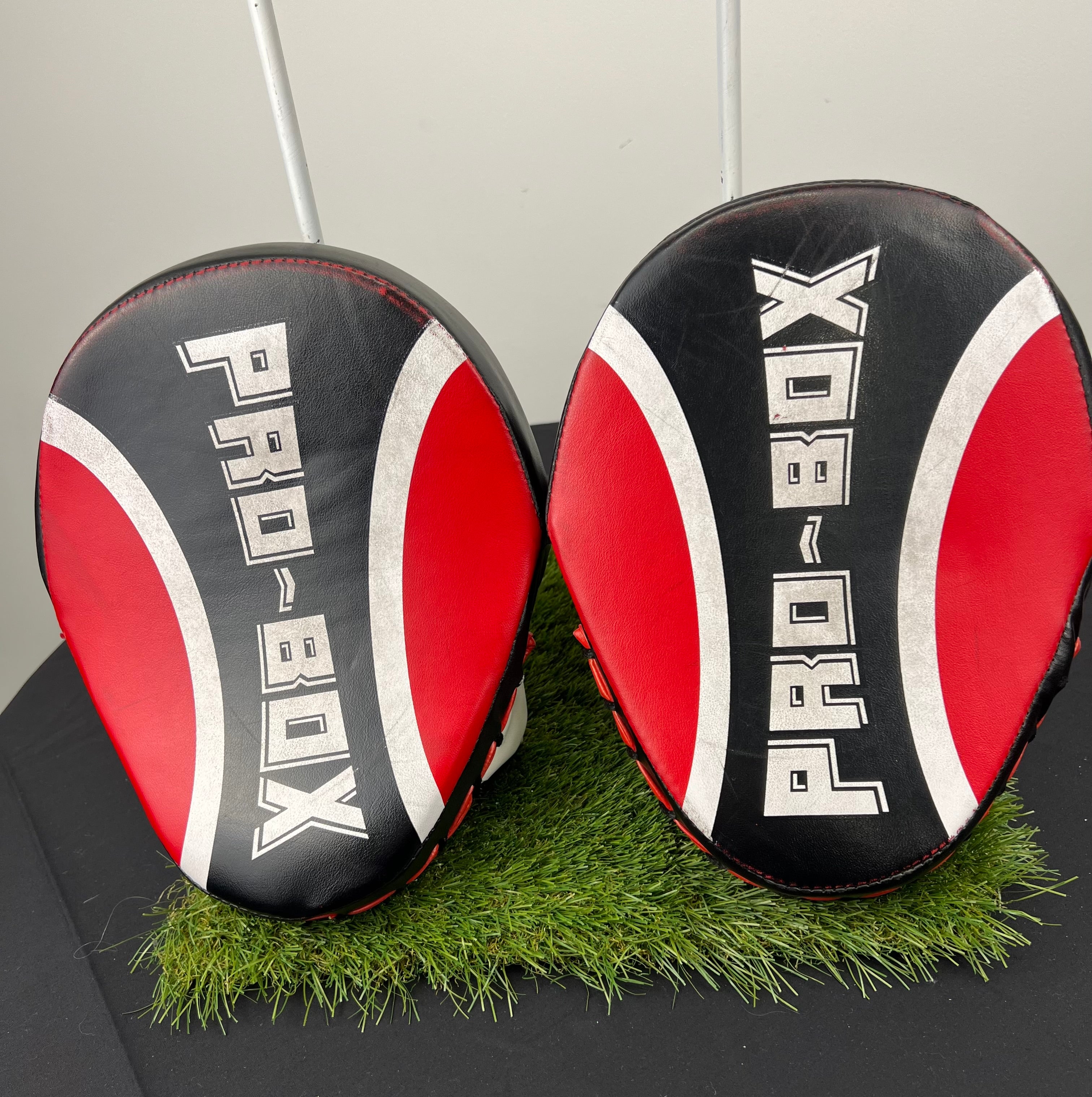 Top view of Pro-Box curved sparring pads showing black, red and white padded striking surfaces with Pro-Box branding