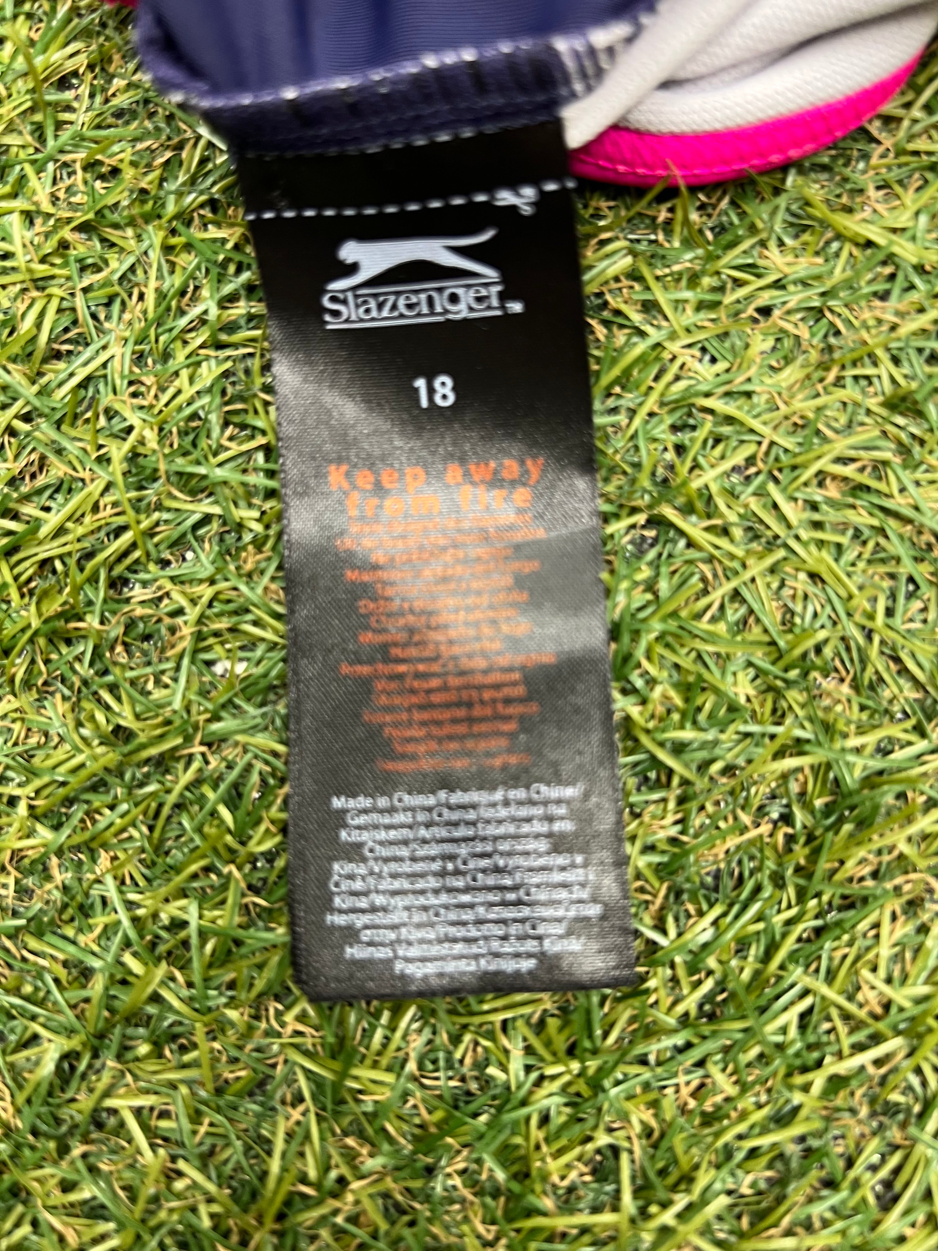 Close-up image of size and care label inside women's Slazenger swimsuit indicating size 18 and care instructions