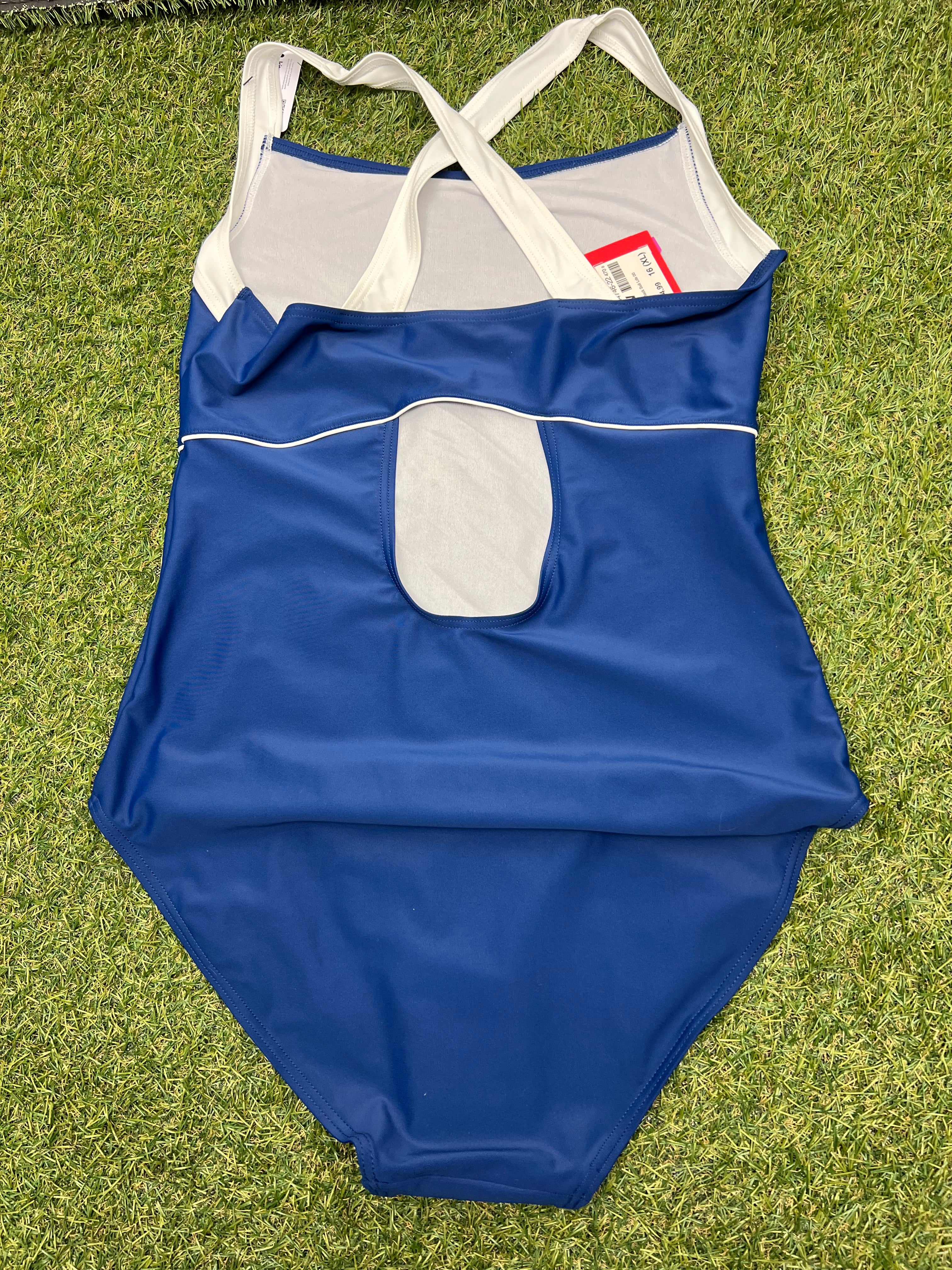 Back view of Women’s Slazenger swimsuit showing keyhole cut-out and cream straps on grass