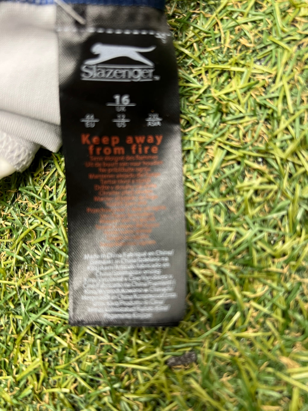 Close-up of Swimsuit label showing brand Slazenger, size 16, and care instructions