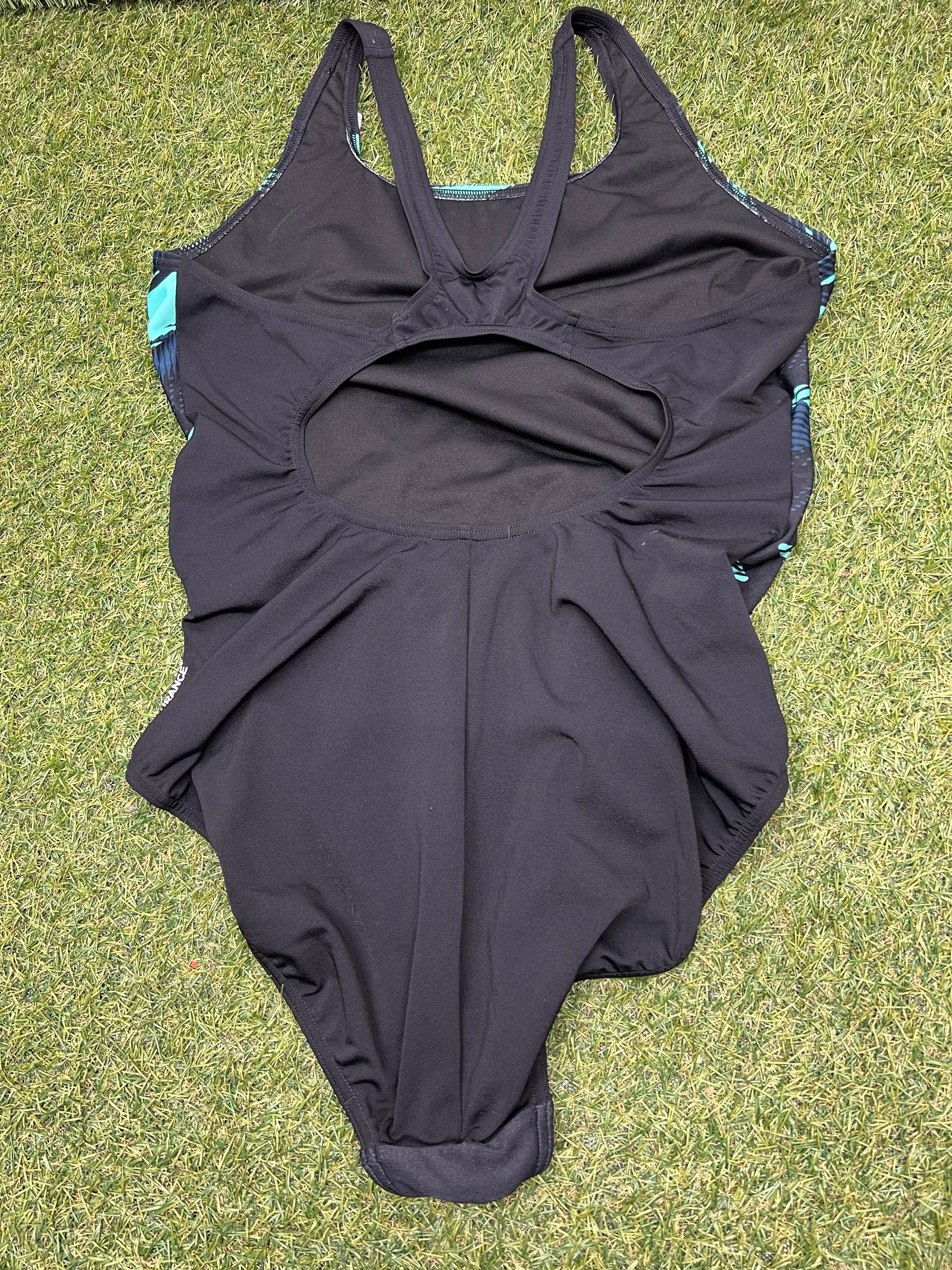 Back view of women’s Speedo swimsuit showing open cut-out design and solid black fabric
