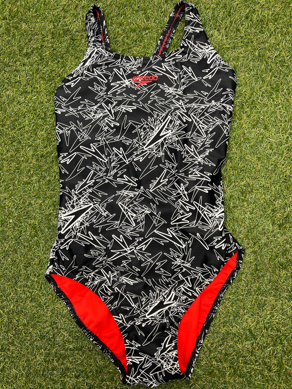 Front view of women's Speedo swimsuit in size 14 with black and white abstract pattern and red lining