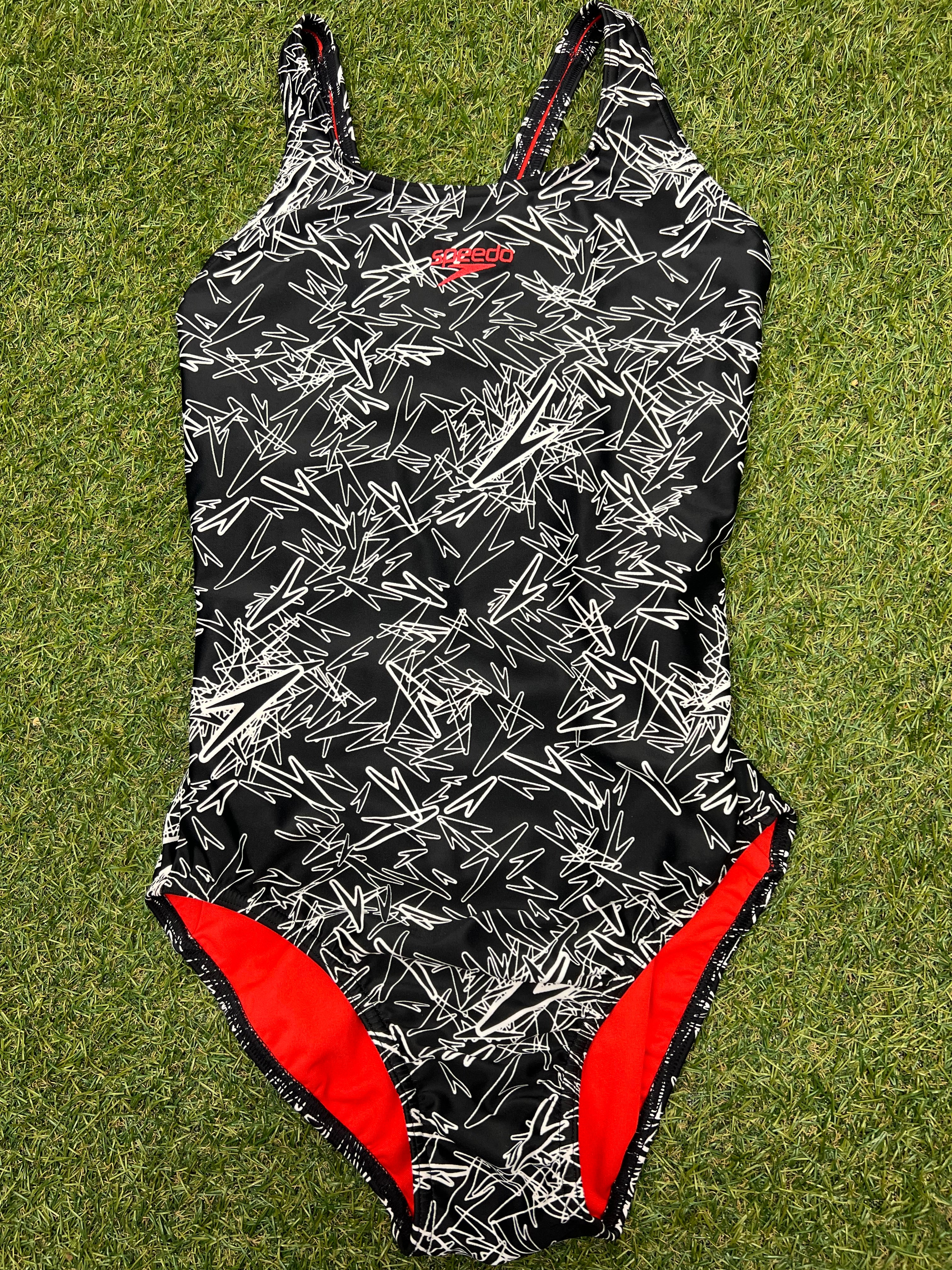 Front view of women's Speedo swimsuit in size 14 with black and white abstract pattern and red lining