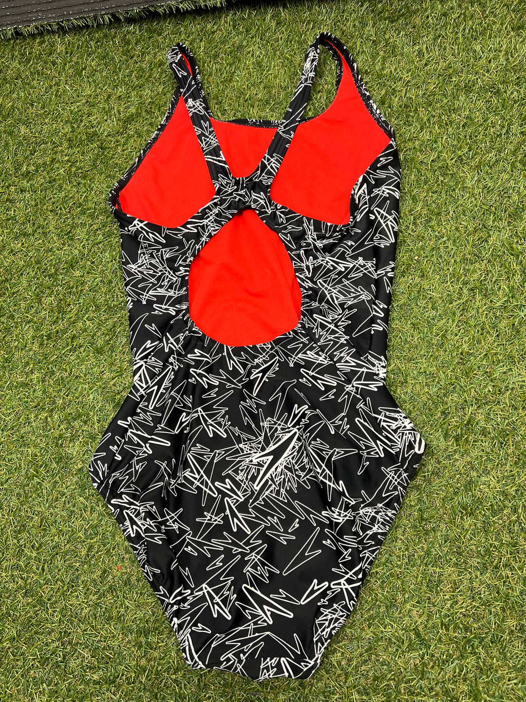Back view of women's Speedo swimsuit with racerback design and red inner lining