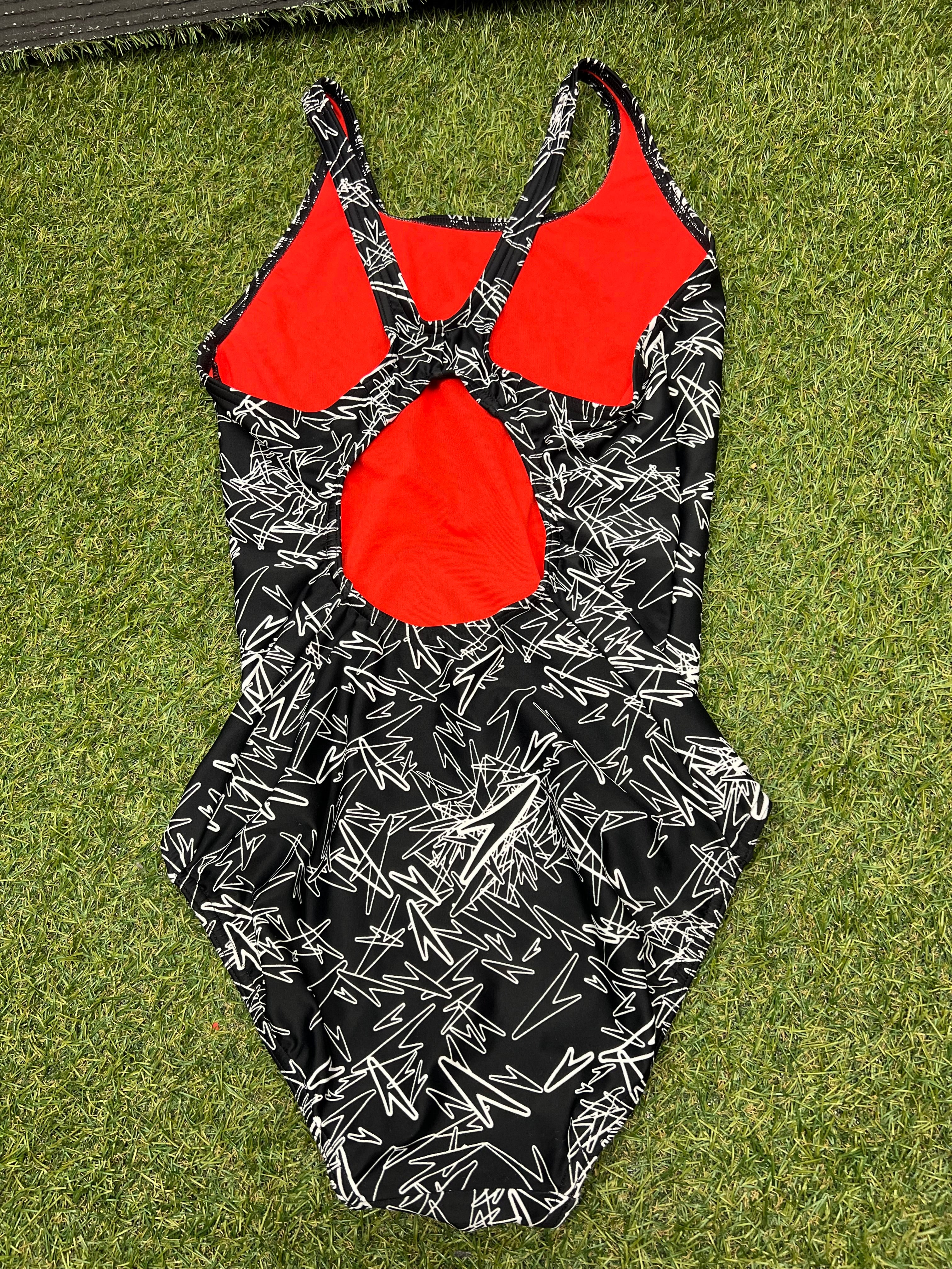 Back view of women's Speedo swimsuit with racerback design and red inner lining