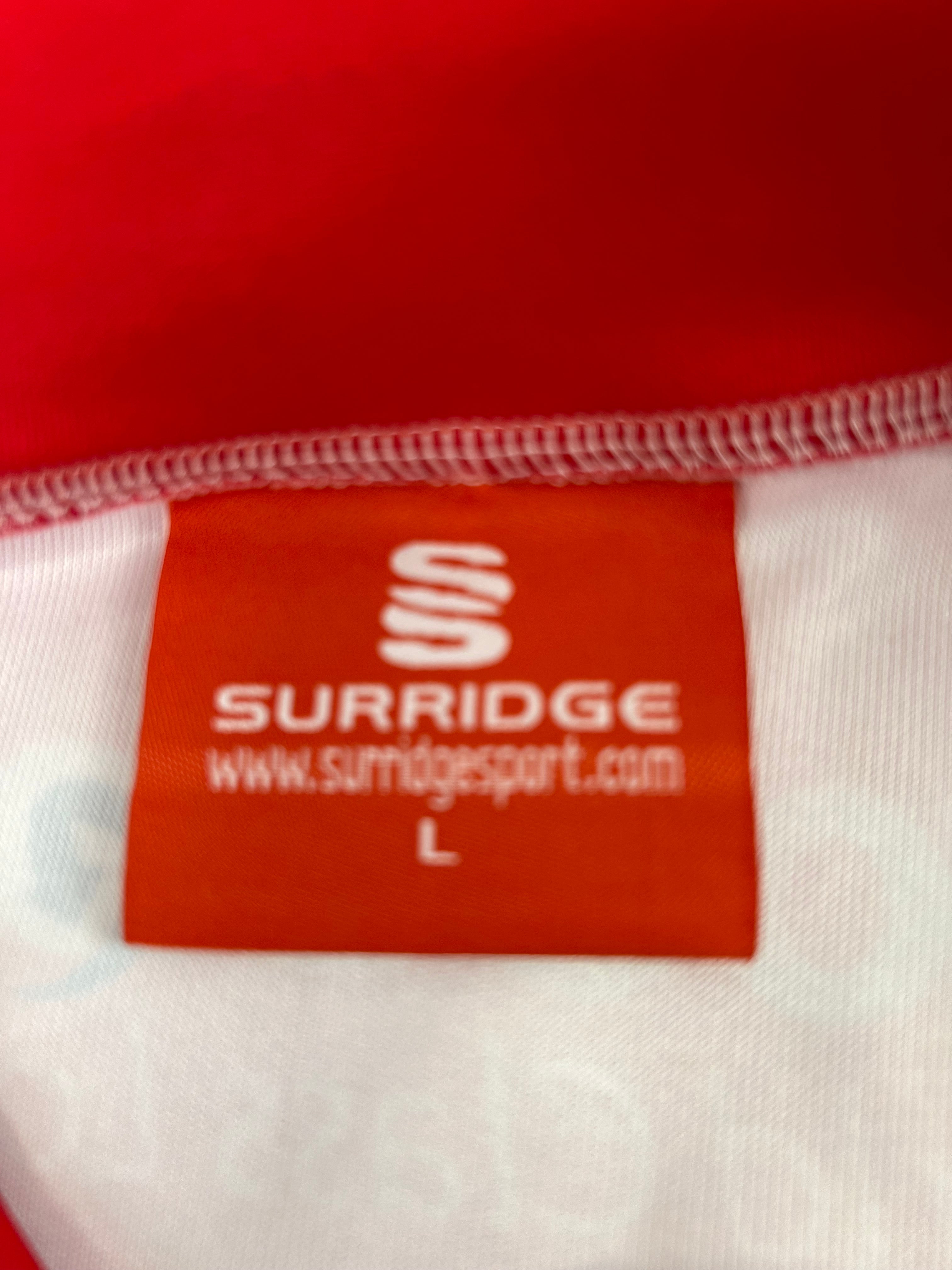 Close-up of red Surridge size L brand label inside the Essex Eagles cricket slipover