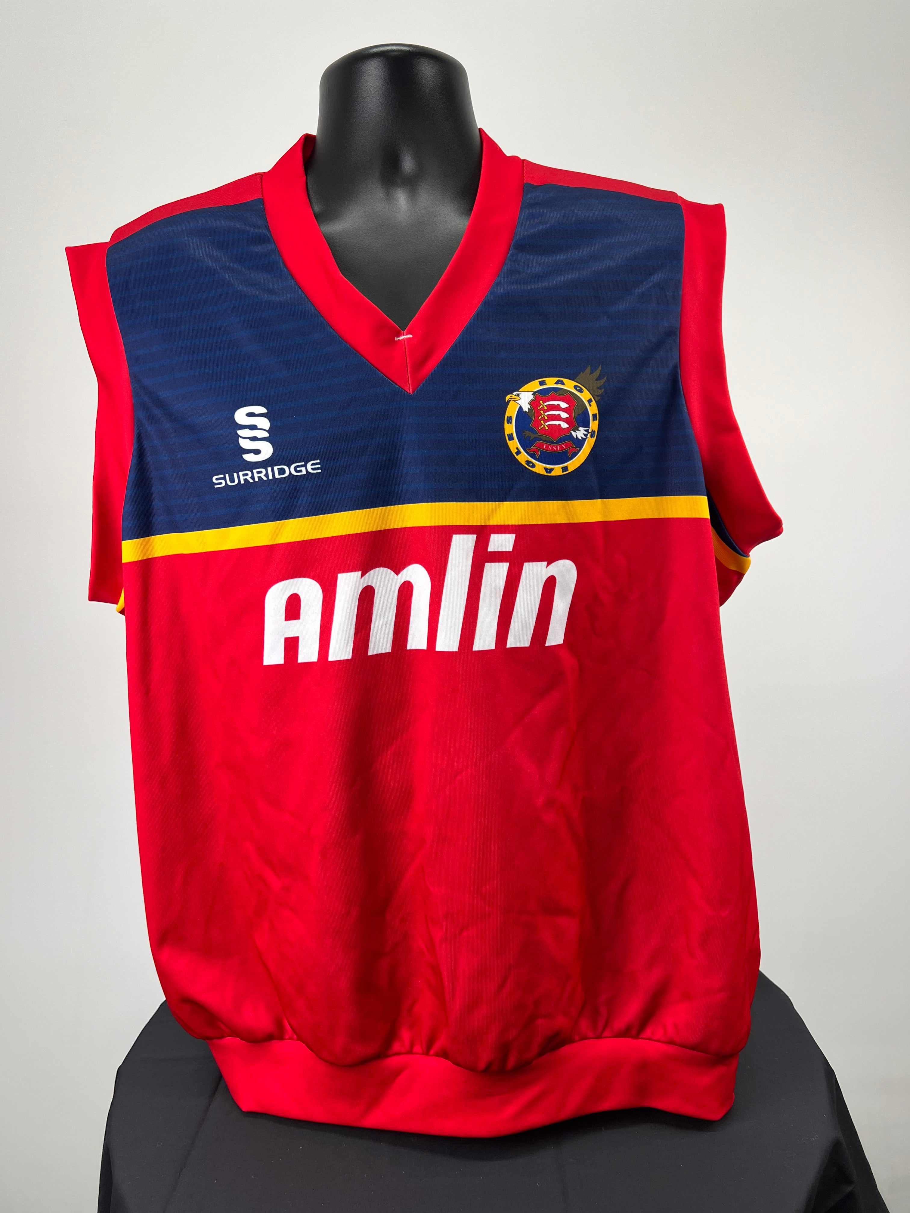 Front view of Essex Eagles cricket slipover with red, navy and yellow colours, featuring Amlin sponsor and team logo
