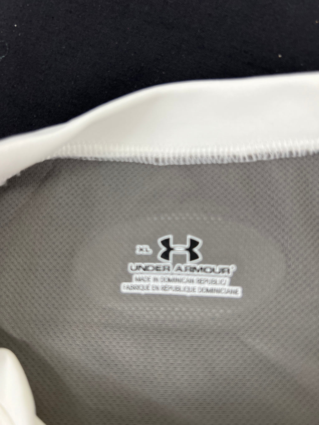 Close-up of inside label showing Under Armour branding and manufacturing details
