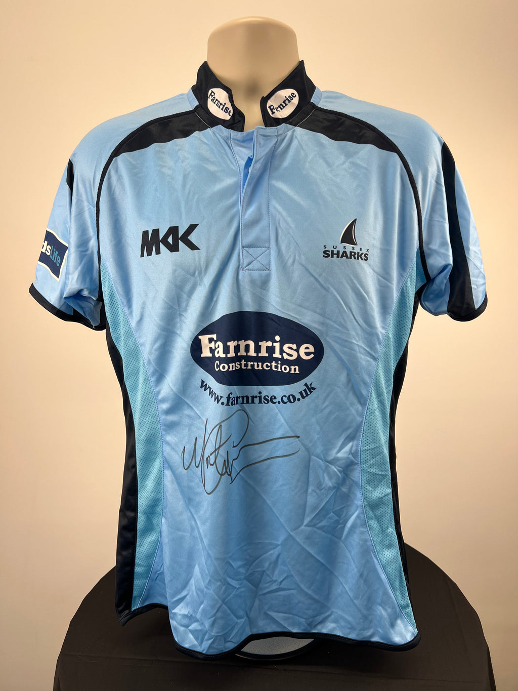 Front view of Sussex Sharks cricket shirt in sky blue with black trims, signed by Monty Panesar