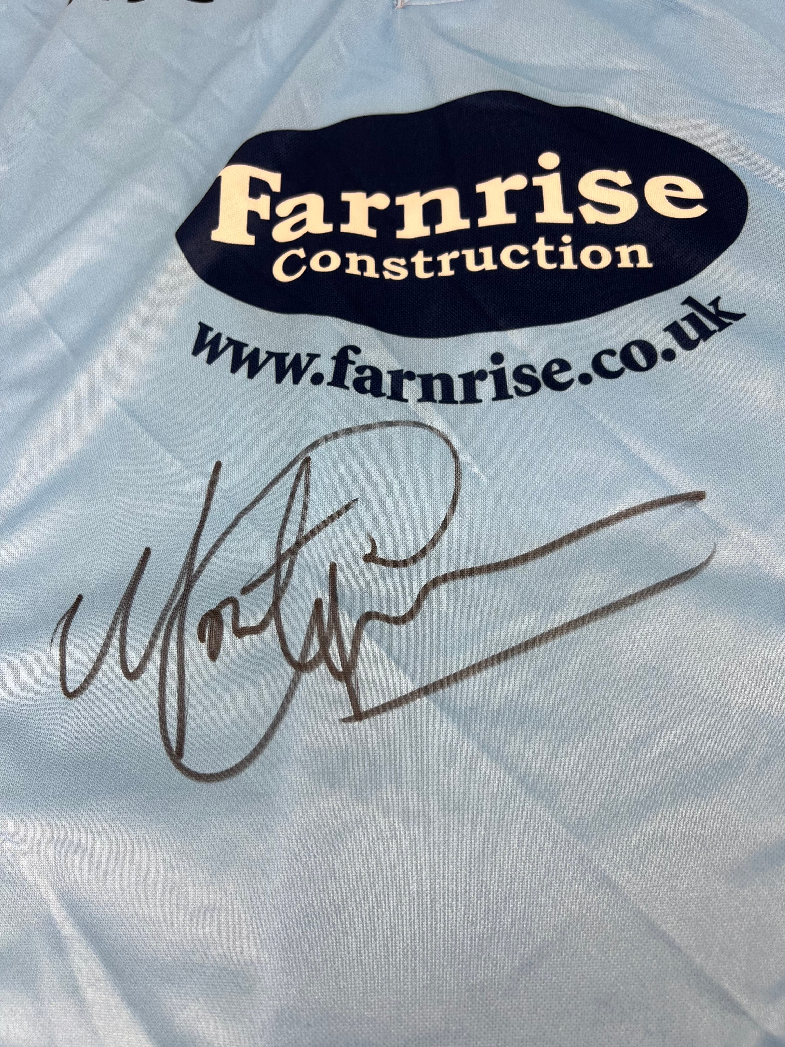 Close-up of Monty Panesar's autograph on the front of the Sussex Sharks cricket shirt near the Farnrise Construction logo