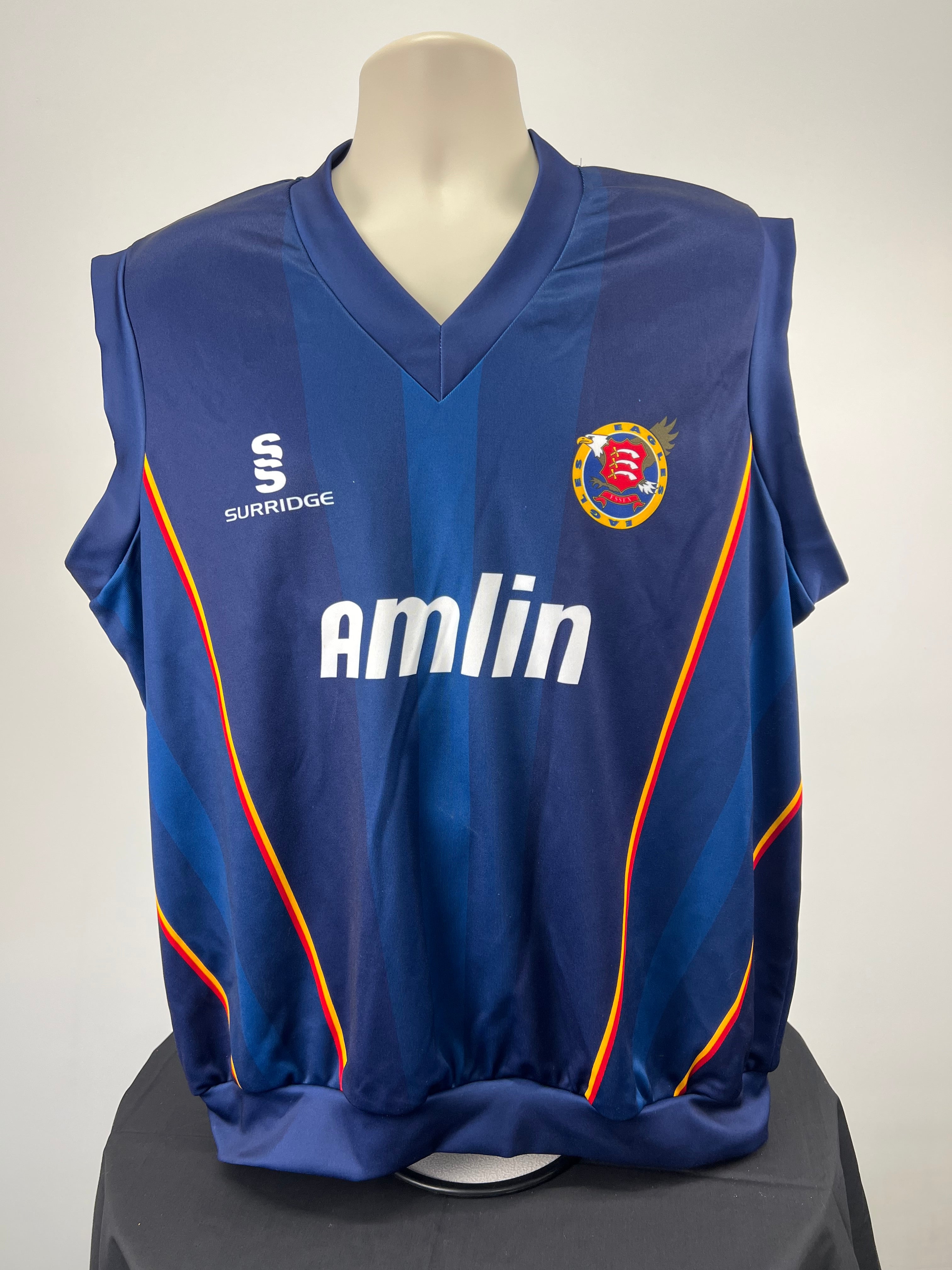 Front view of navy blue Essex Eagles cricket vest with Essex logo, Amlin sponsor and Surridge brand sign