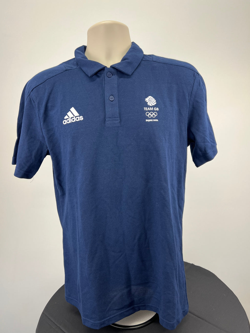 Front view of Adidas Team GB polo shirt in indigo blue with Adidas logo and Team GB emblem
