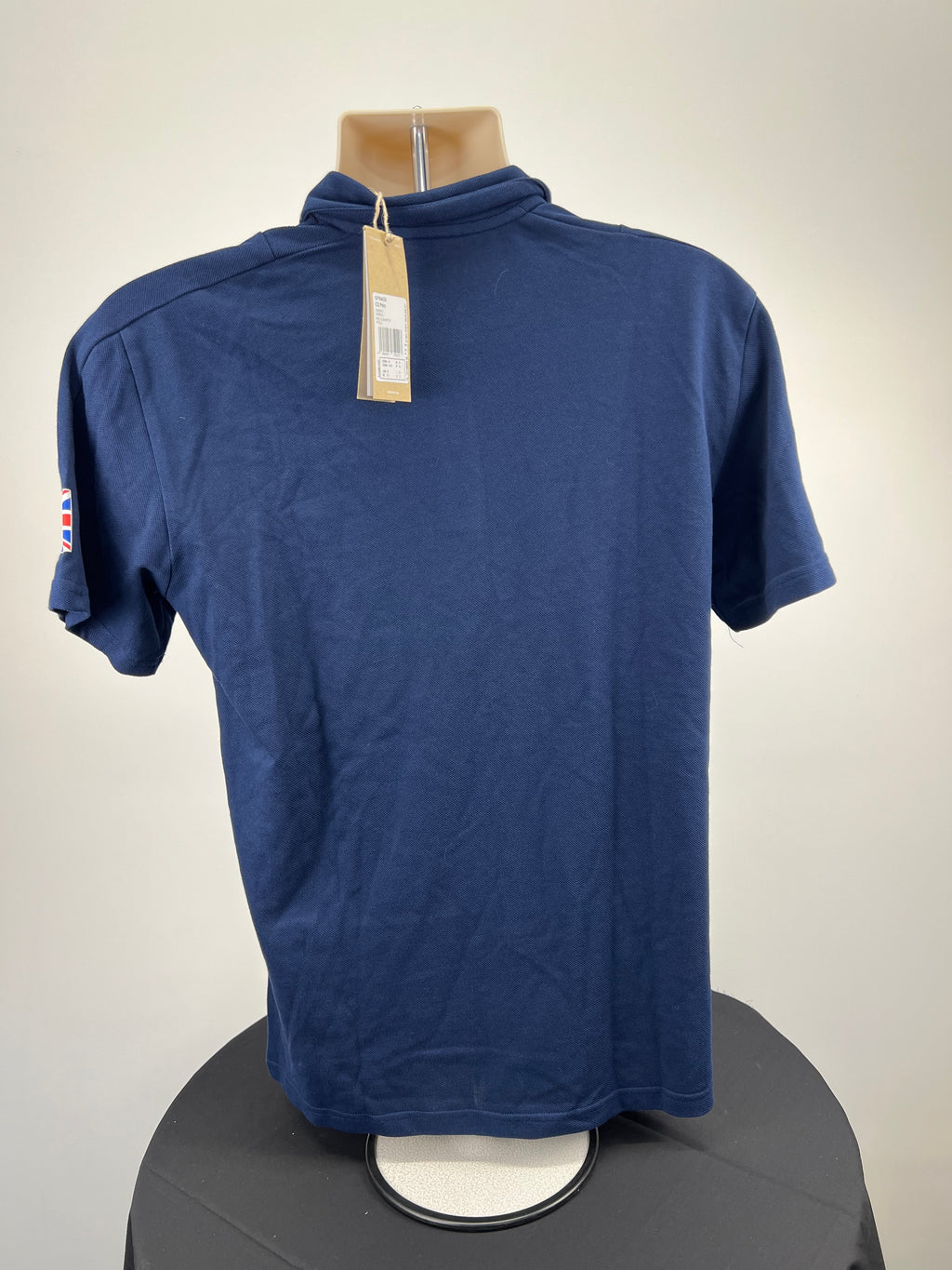 Back view of the indigo Adidas Team GB polo shirt showing plain design with tag attached