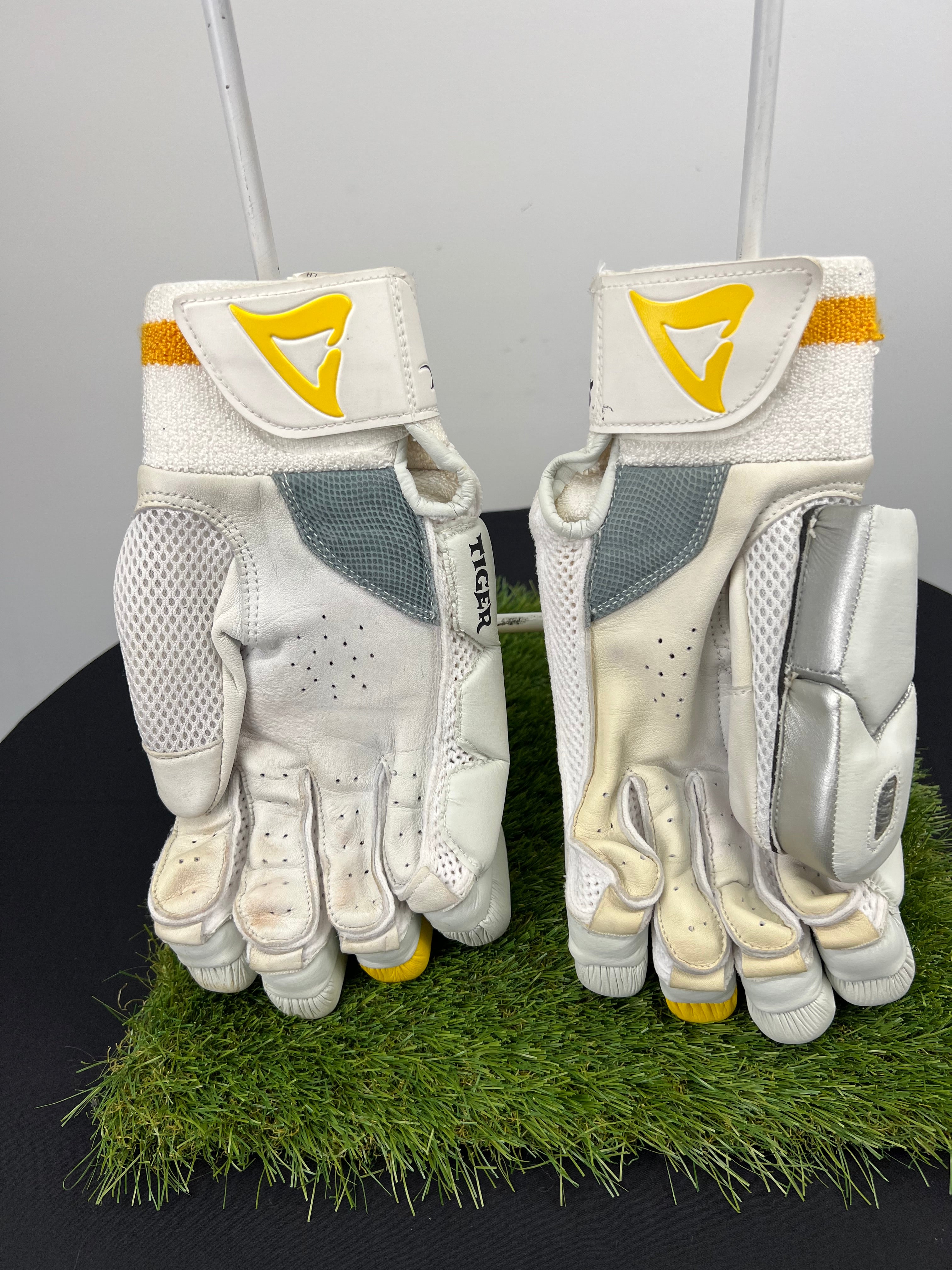 Back view of Shark left hand cricket batting gloves showing mesh and leather palm with wrist strap and ventilation details