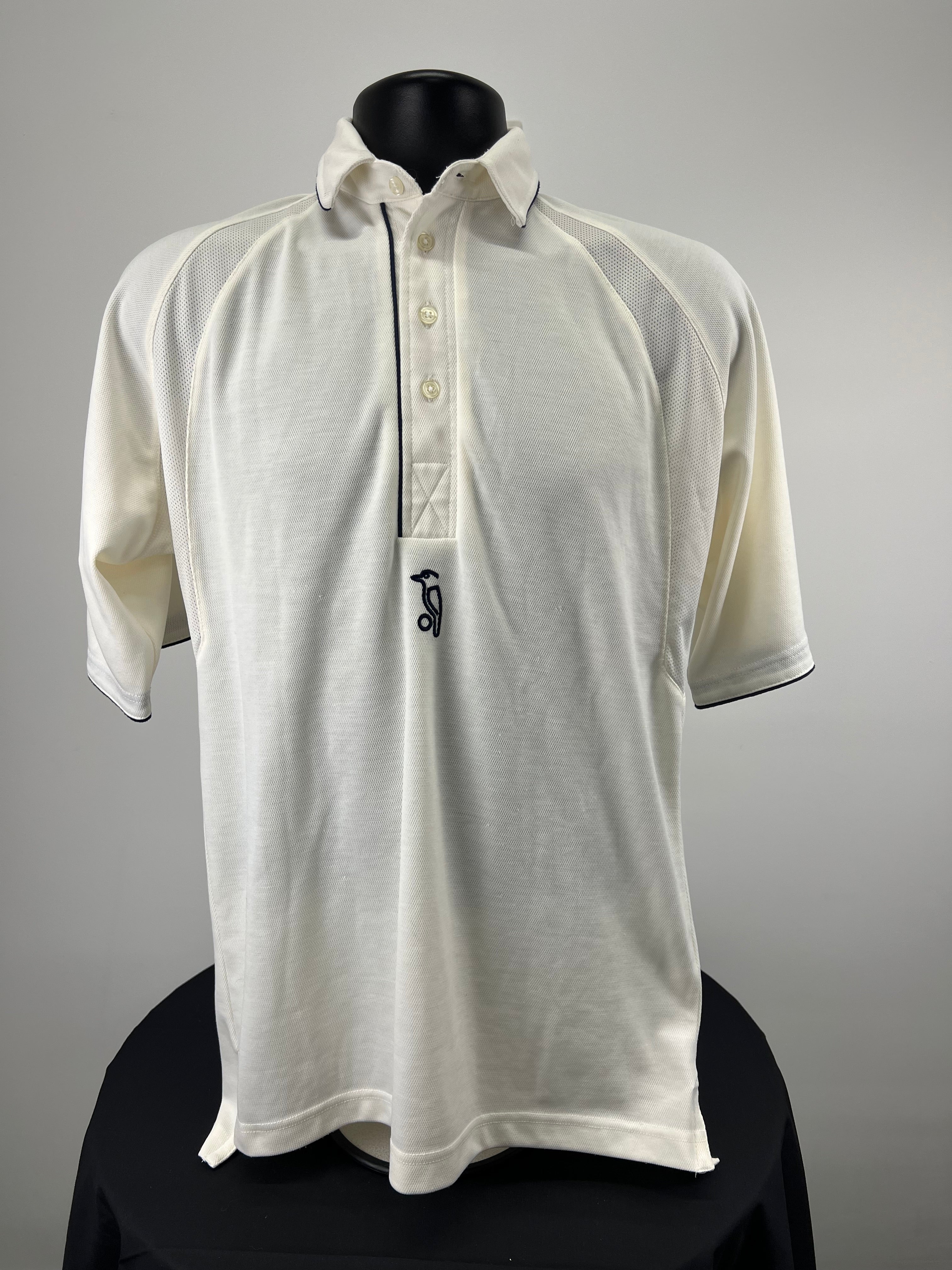 Front view of Kookaburra cricket polo shirt in white with navy piping on collar and sleeves