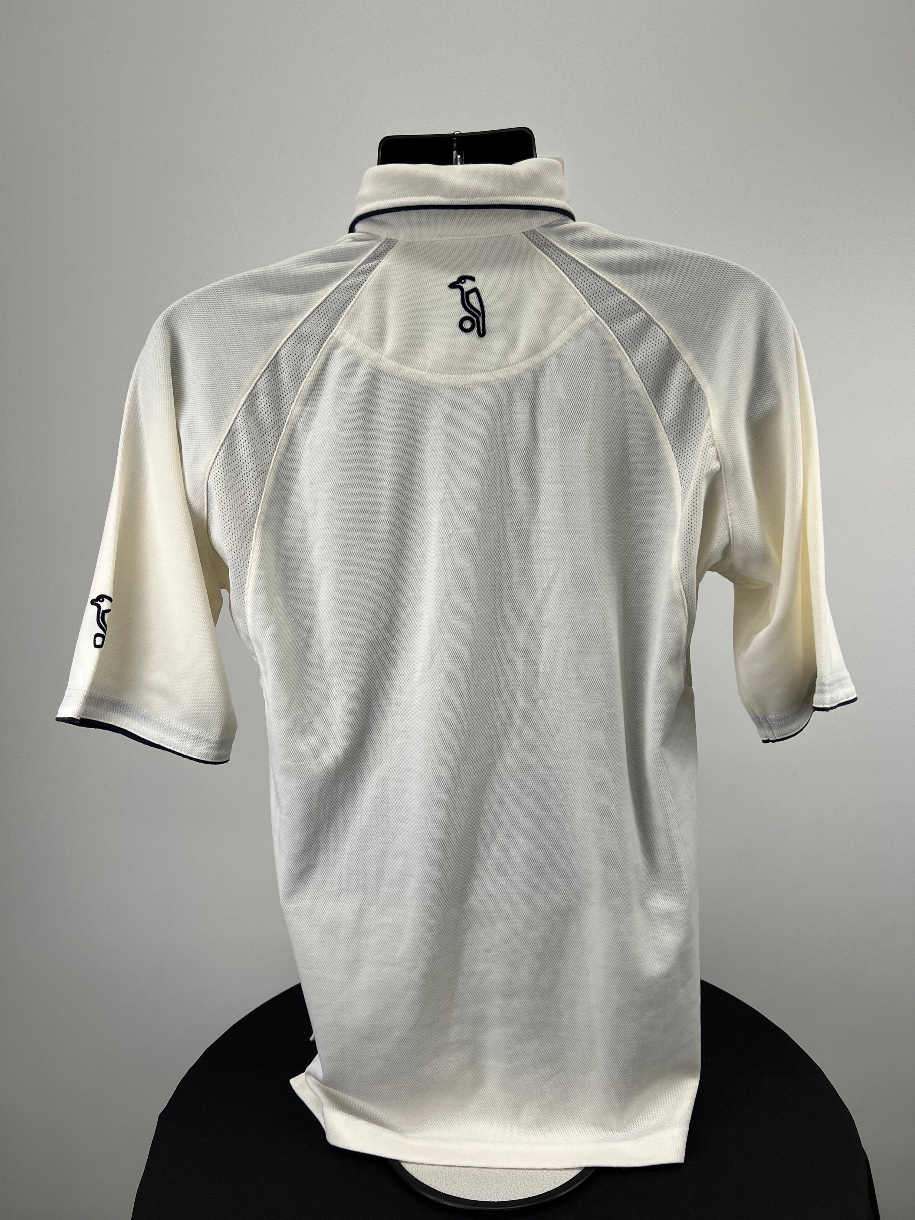 Back view of Kookaburra cricket polo shirt showing logo embroidery and mesh shoulder panels