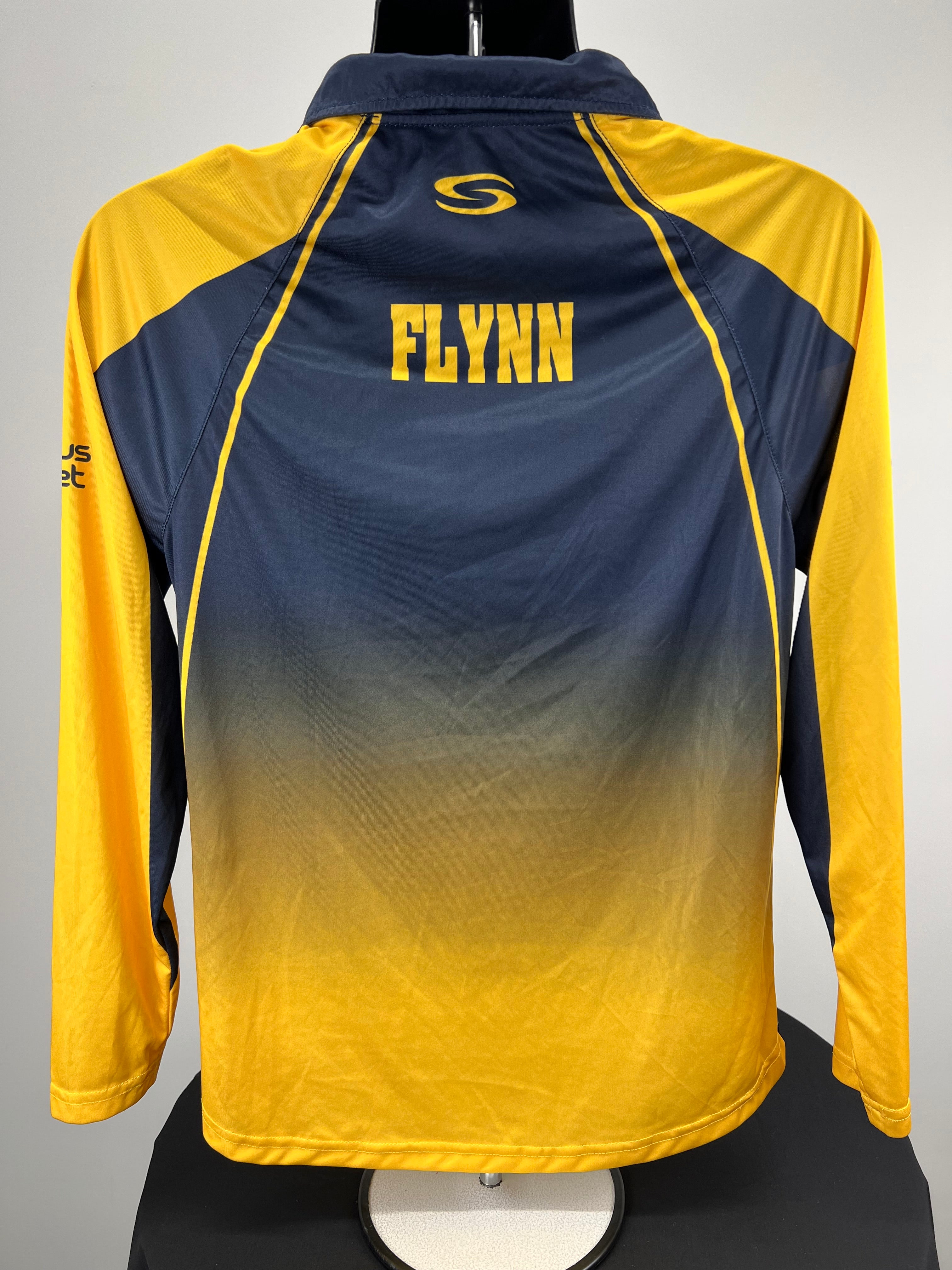 Back view of Hampshire Cricket Board cricket top showing yellow 'FLYNN' name print on navy and yellow background