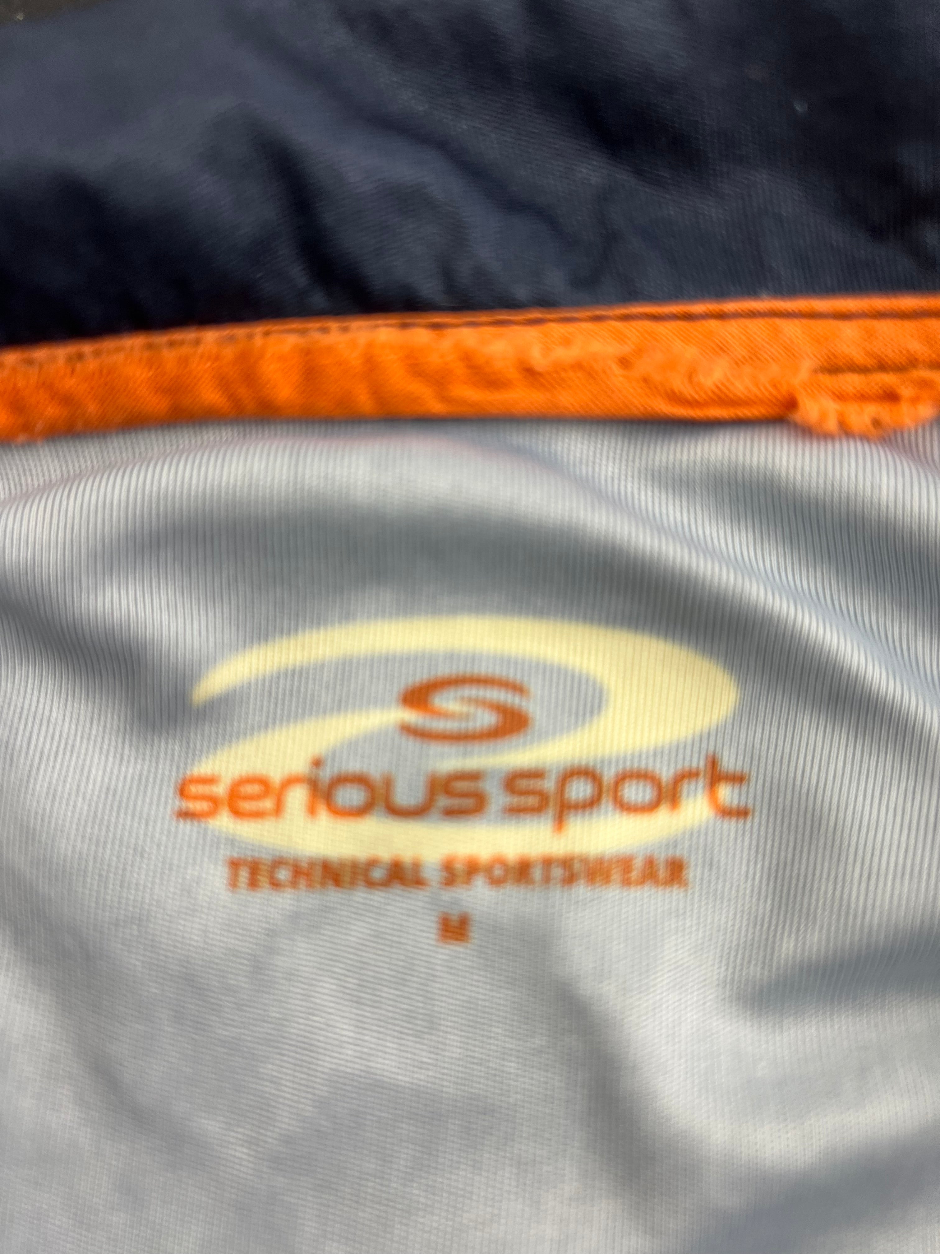 Close-up of inner label showing Serious Sport technical sportswear brand and size M