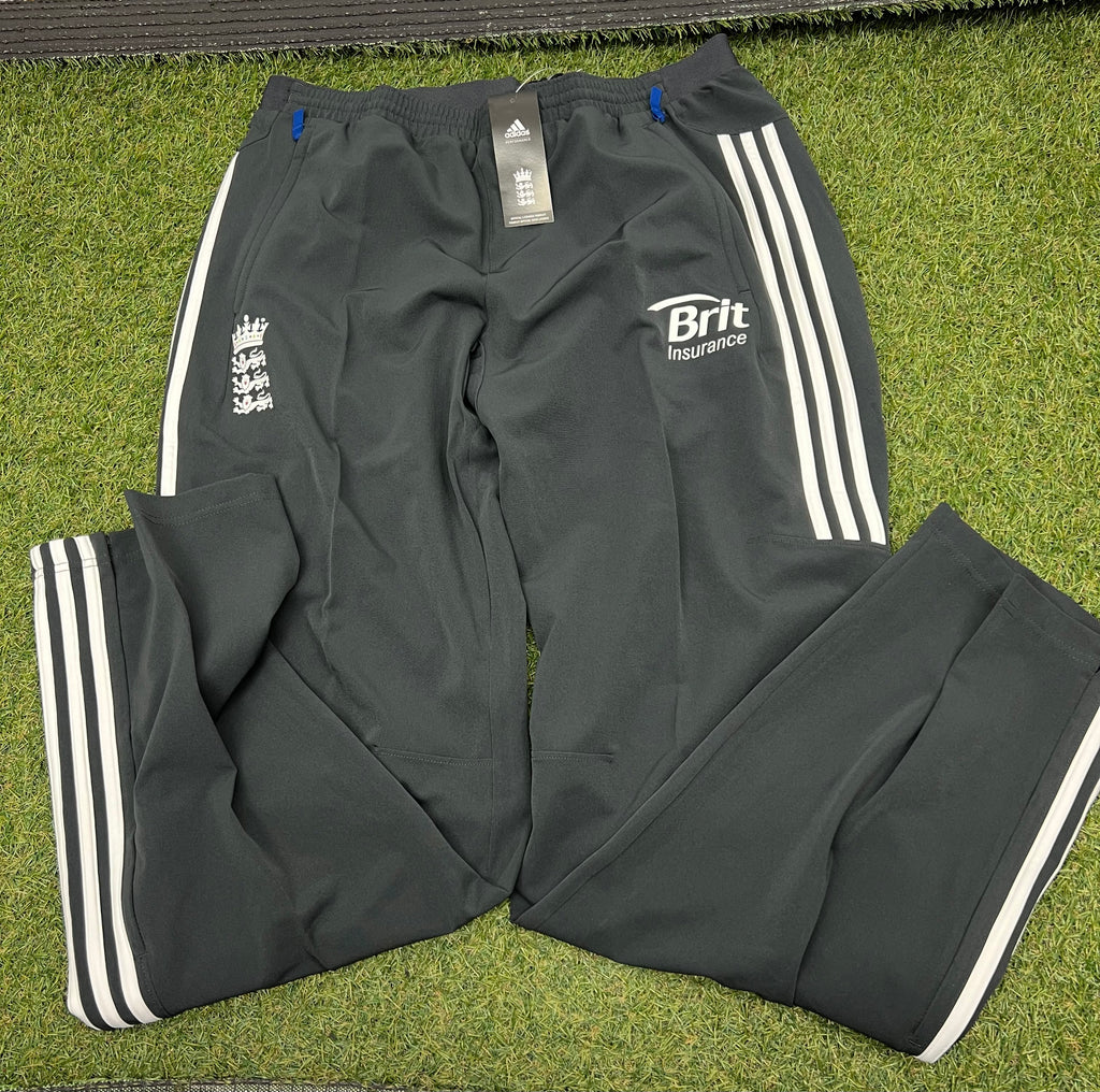 Front view of men’s adidas ECB tracksuit bottoms dark shake with white stripes and ECB logos