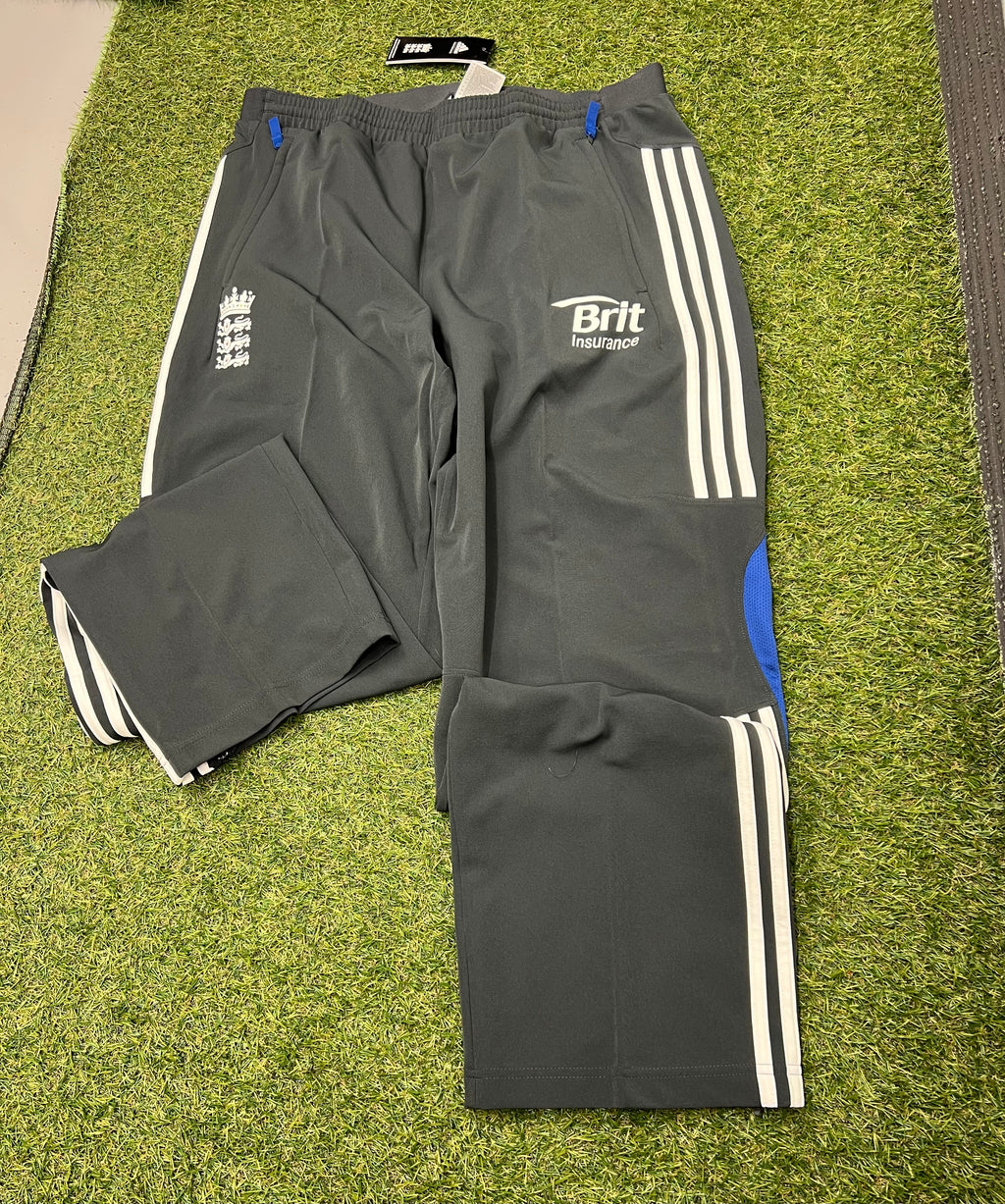 Side view of men’s adidas ECB tracksuit bottoms showing elastic waistband and blue mesh panels