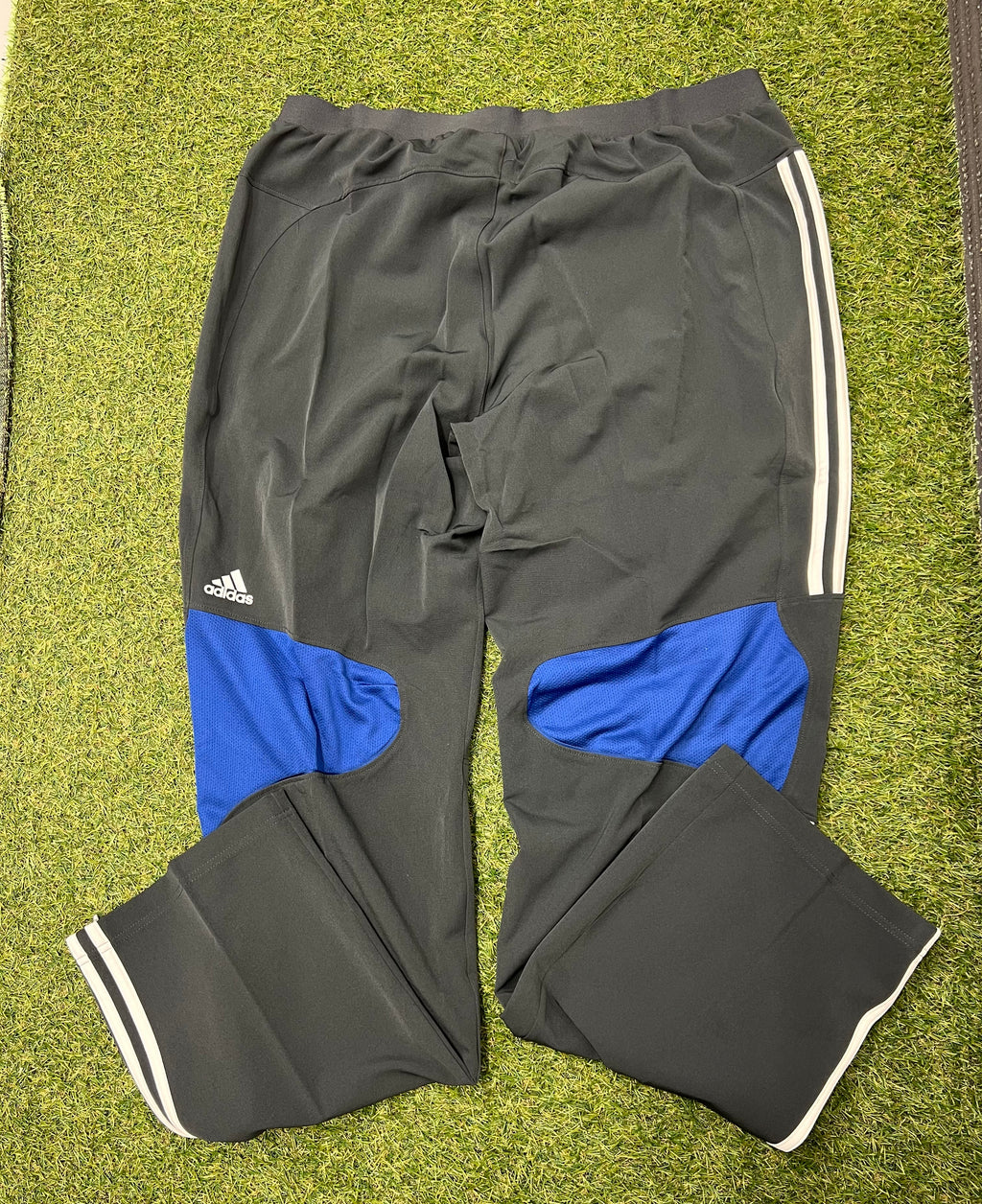 Back view of men’s adidas ECB tracksuit bottoms featuring blue mesh panels and adidas logo