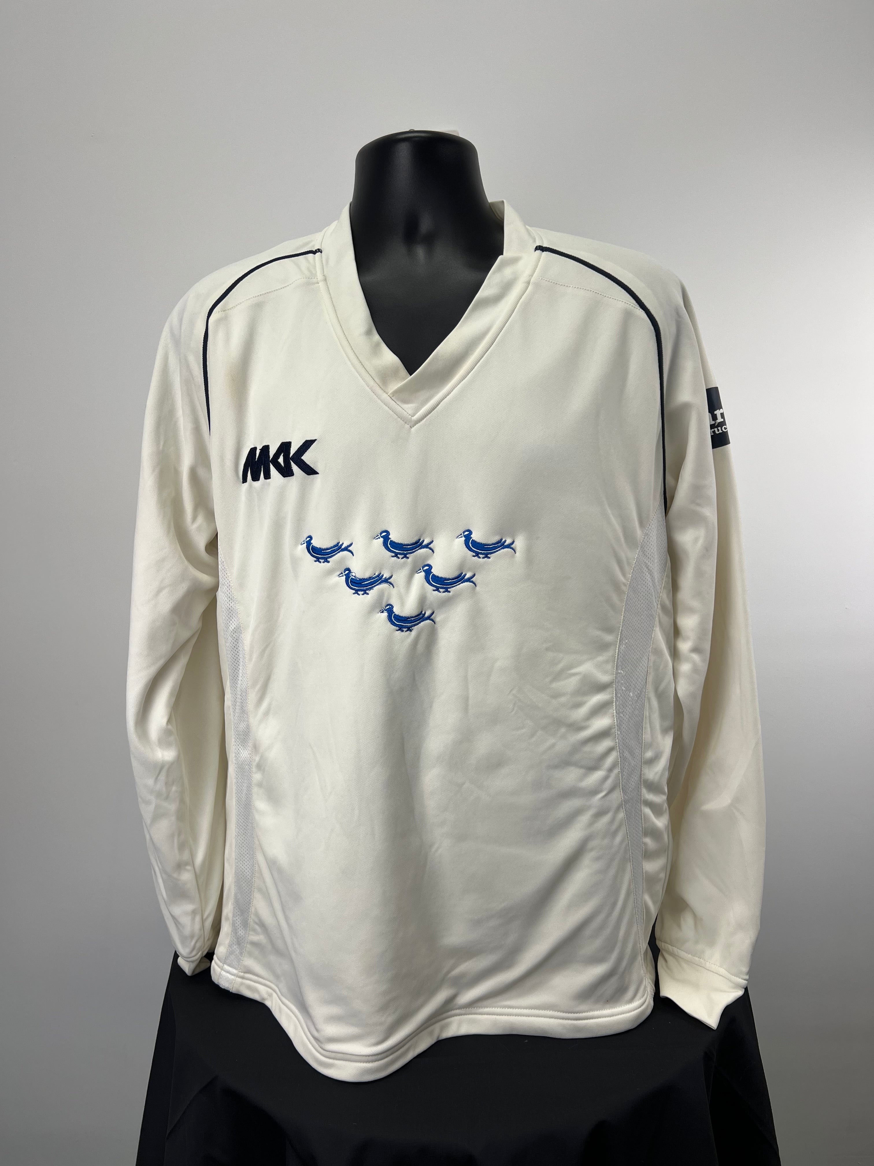 Front view of Monty Panesar cream long sleeve cricket jumper with Sussex logo and MKK branding