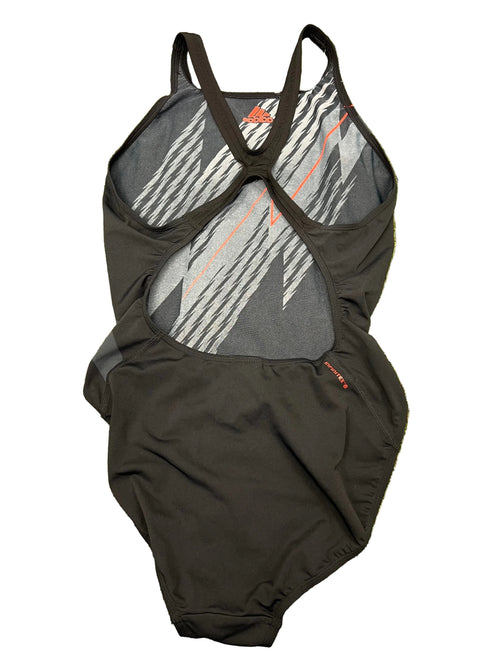 Back view of Adidas Infinitex black swimsuit showing cut-out back design with racer straps on green grass