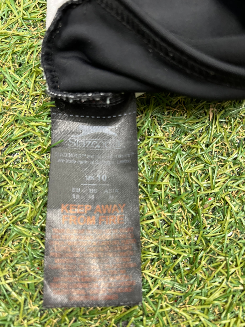 Close-up of Slazenger swimsuit care and size label indicating UK size 10