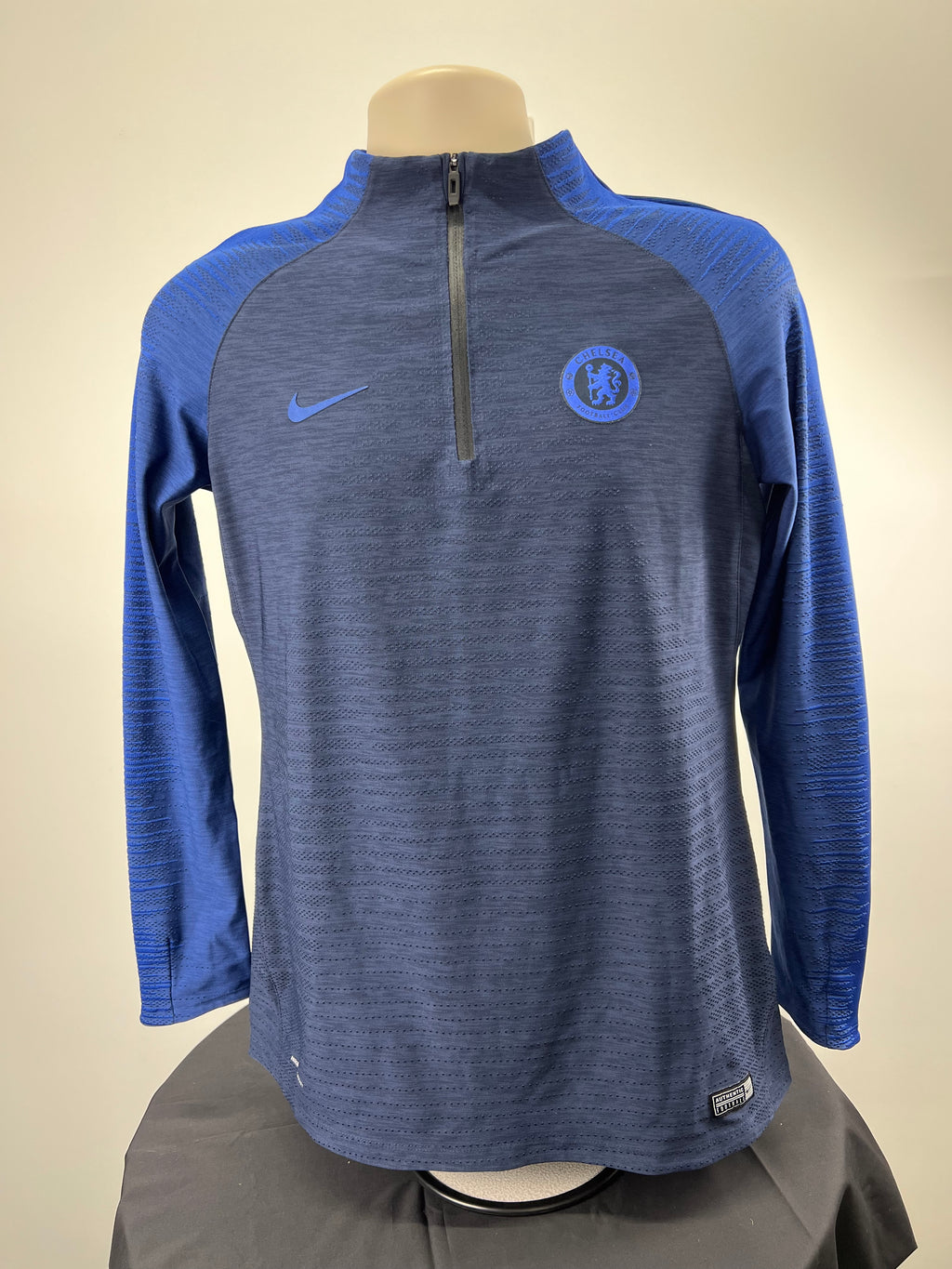 Front view of Chelsea FC long sleeve Nike VaporKnit training top in dark blue with light blue sleeves and half zip