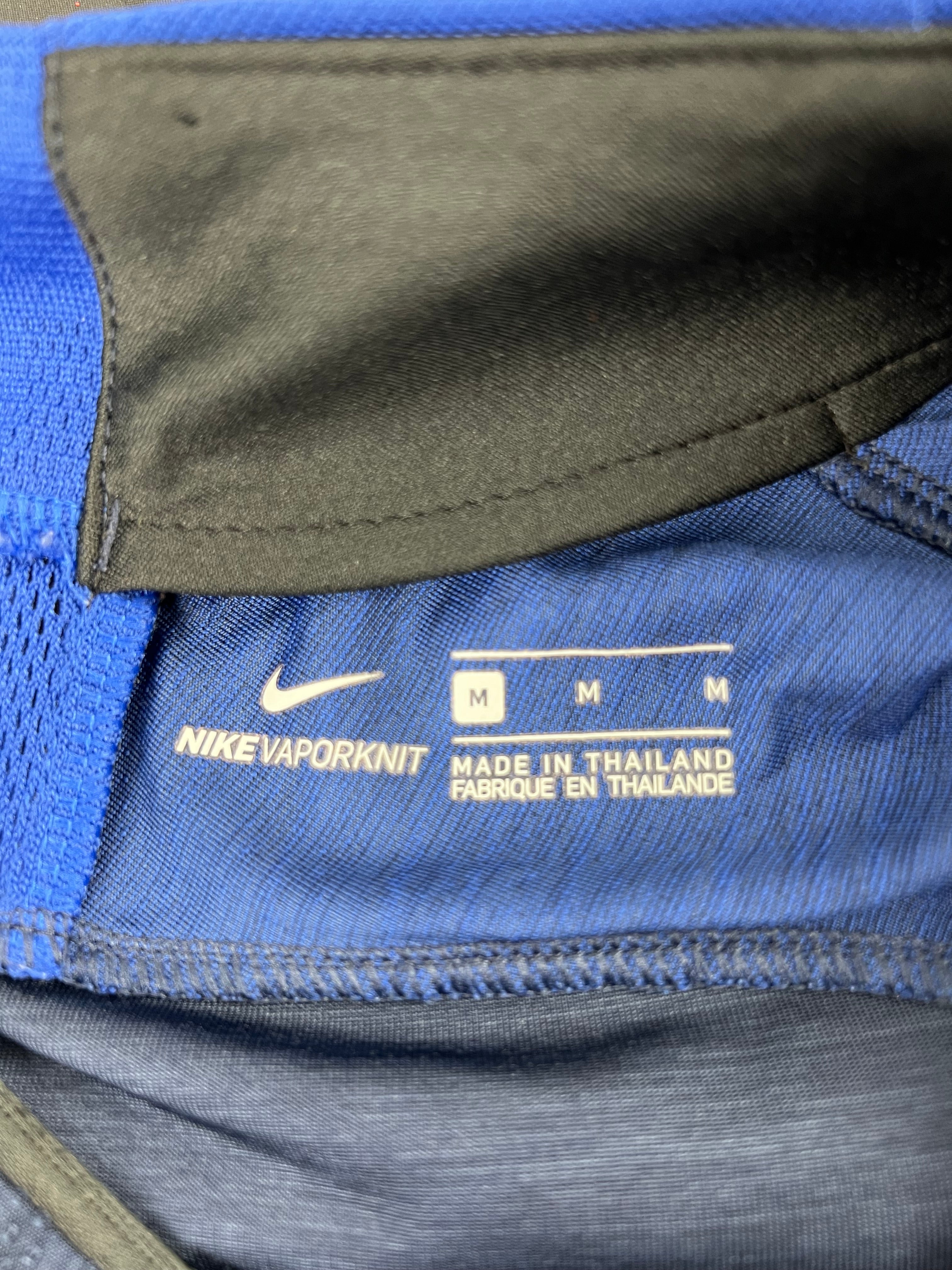 Close-up of Nike VaporKnit label inside the training top showing size Medium and made in Thailand
