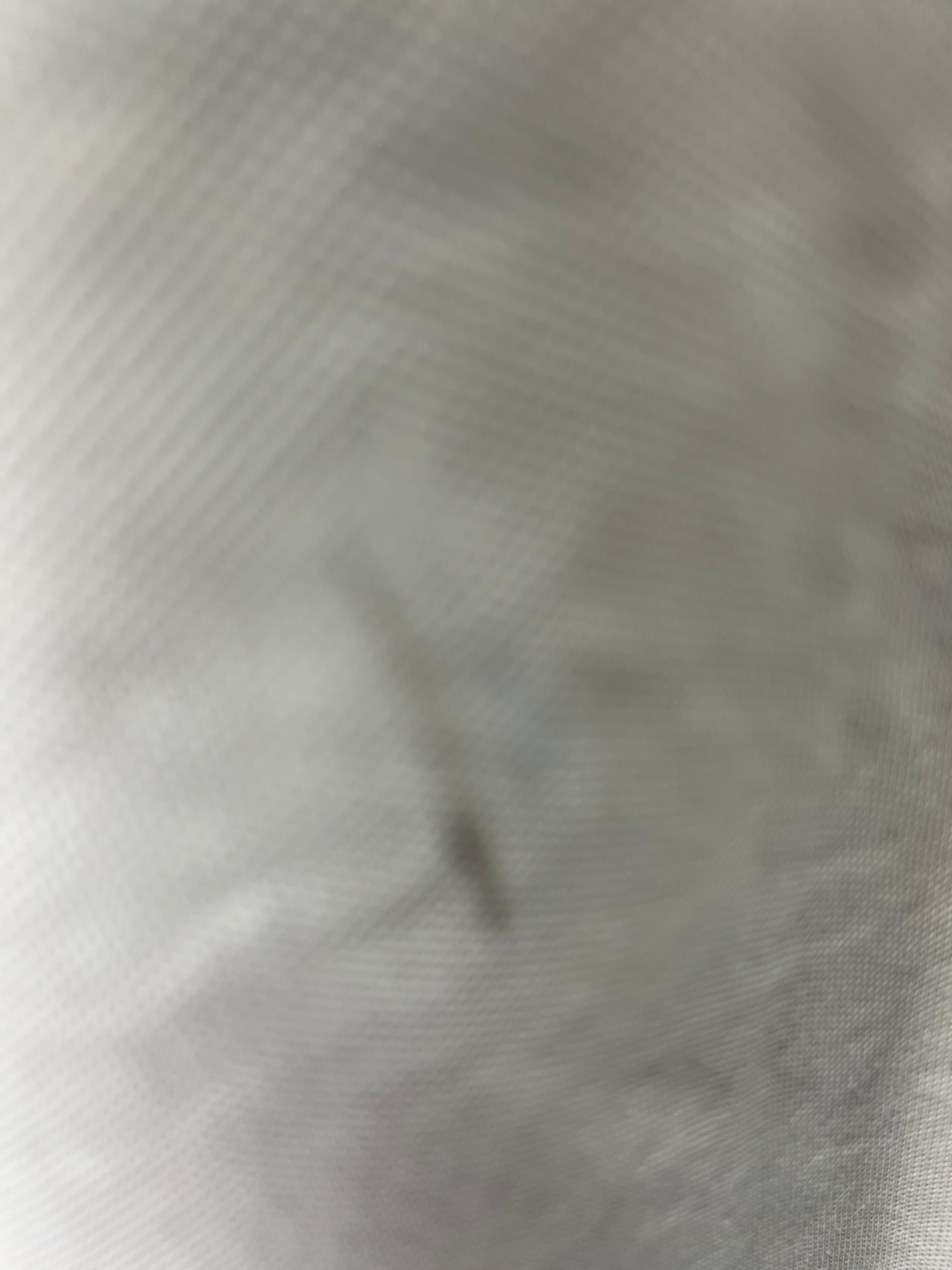 Close-up image showing minor discoloration and wear on fabric of cricket jumper