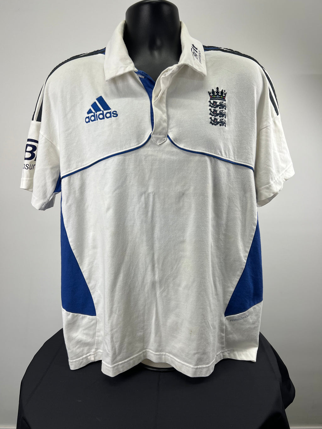 Front view of men's England cricket polo shirt XL with white and blue Adidas design