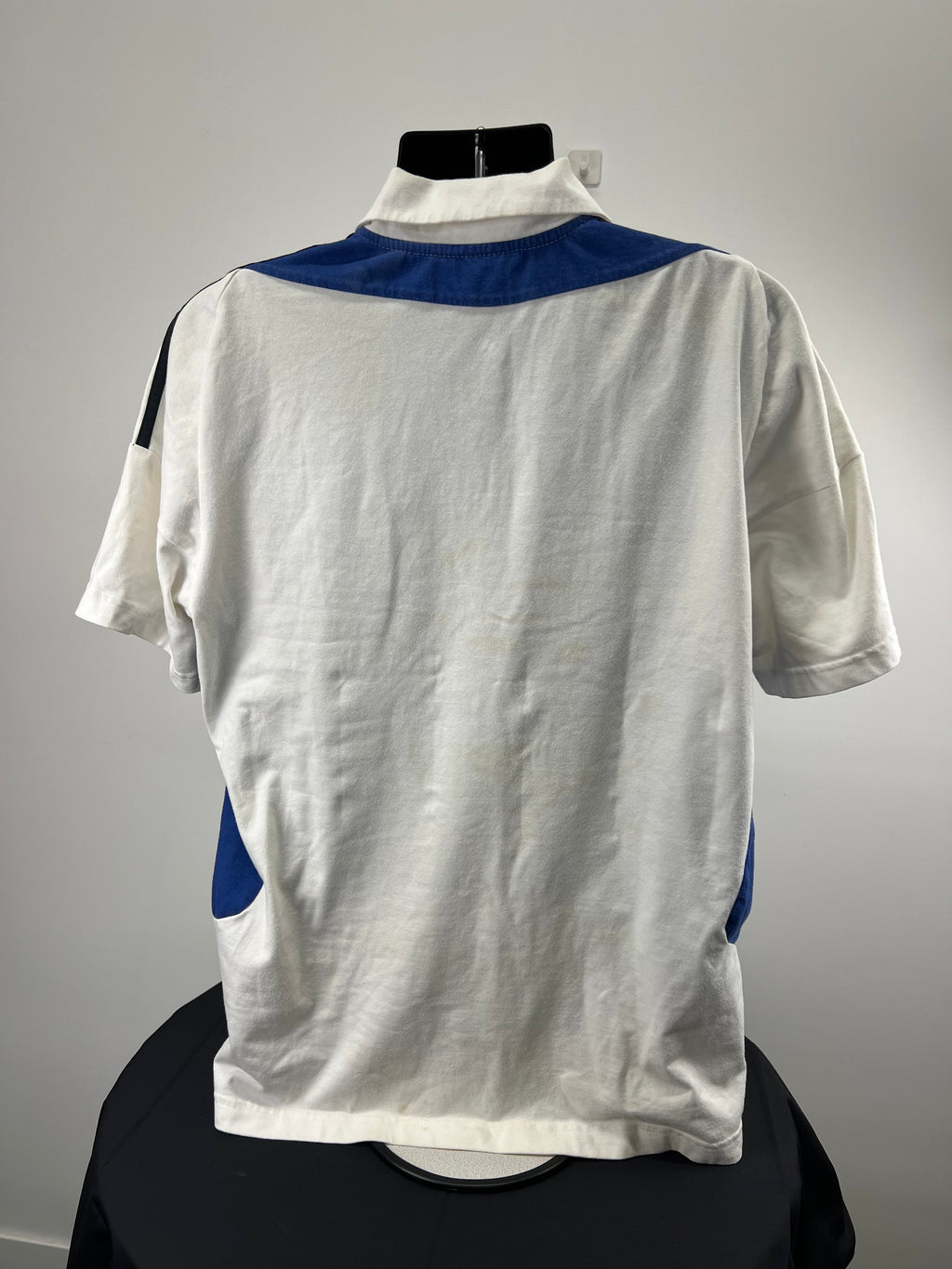 Back view of men's England cricket polo shirt showing white fabric and blue accents