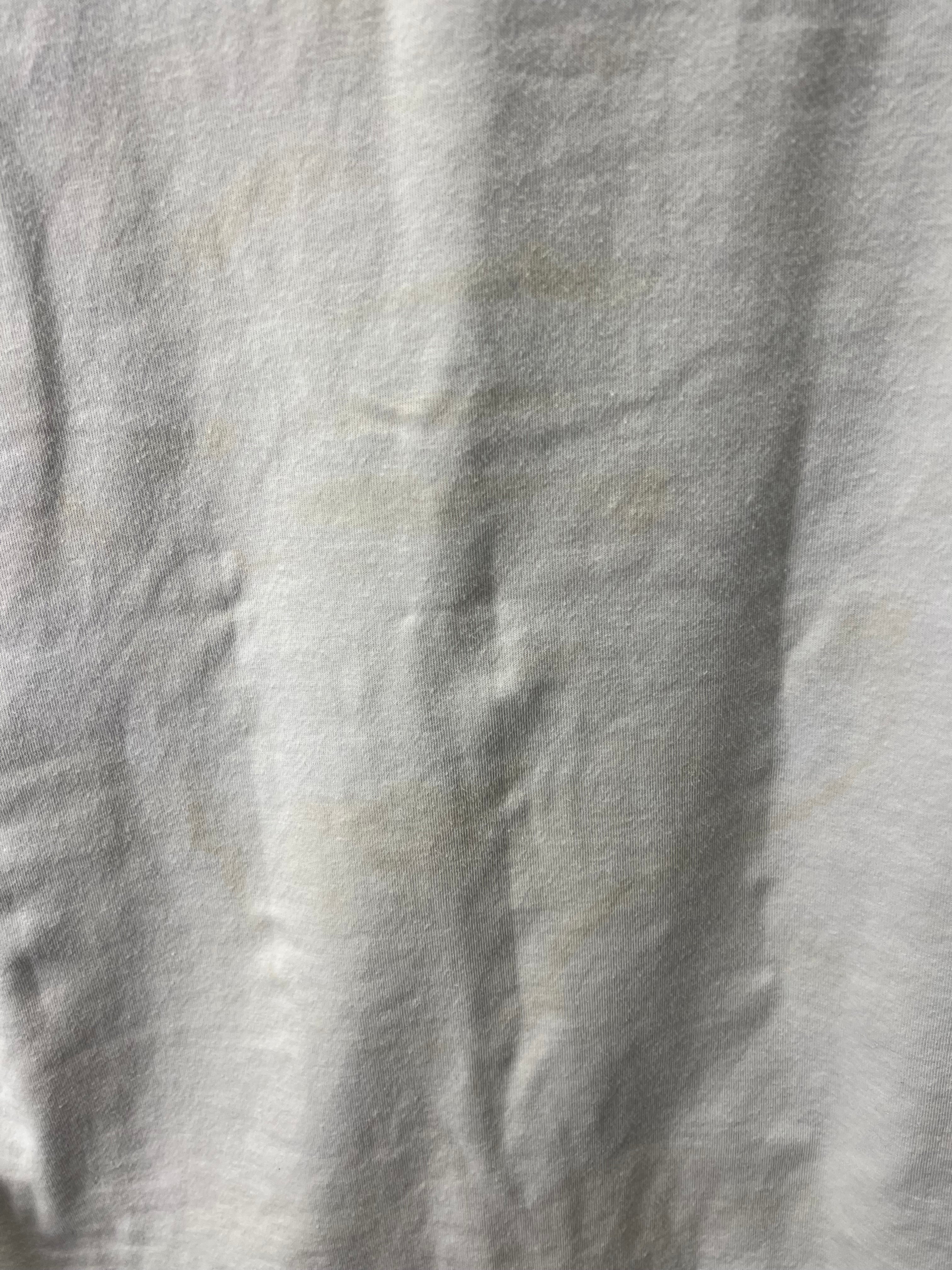Close-up of light discoloration marks on the back of the cricket polo