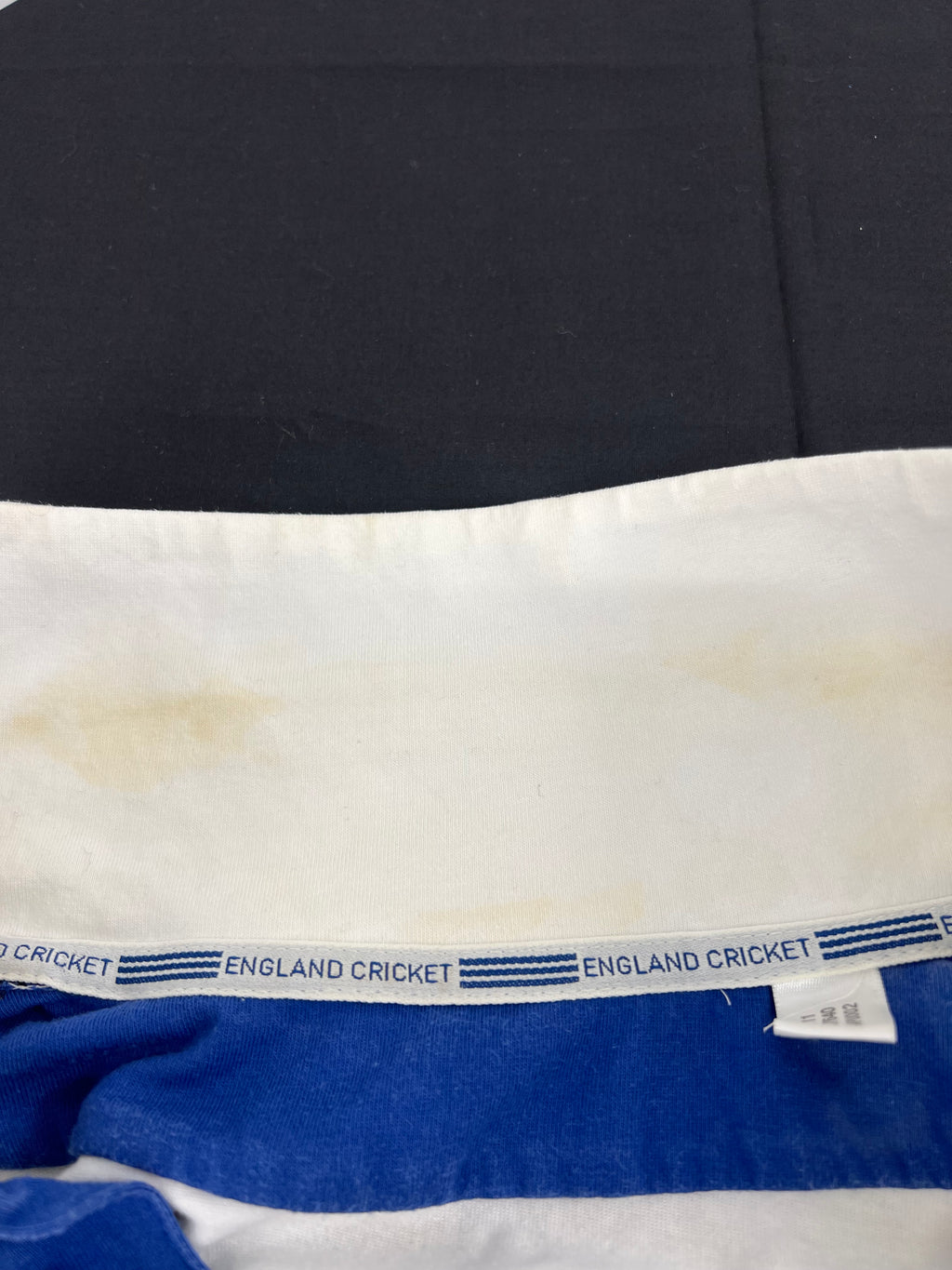 Close-up inside collar view with 'England Cricket' label on shirt donated by Monty Panesar