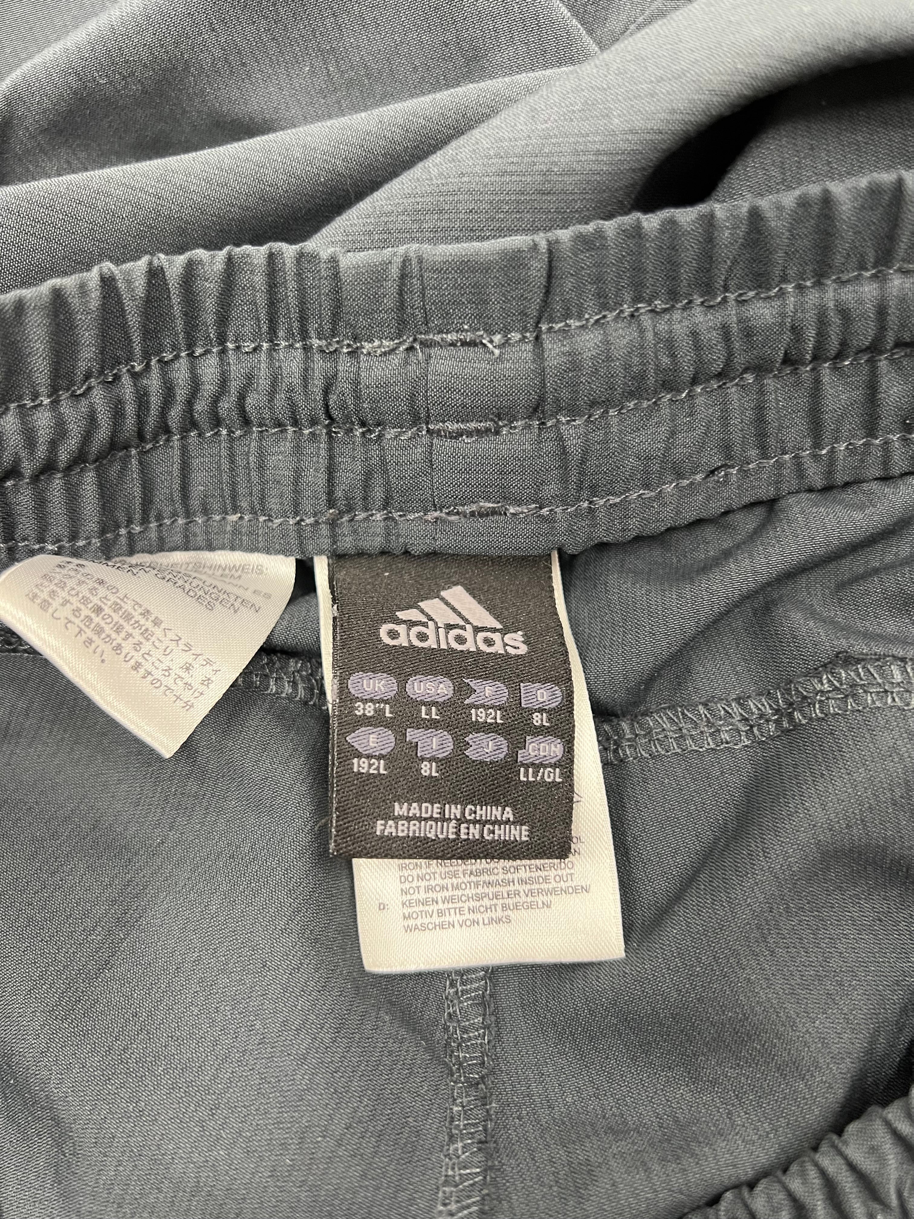 Label inside tracksuit trousers showing adidas branding and size 38L information