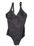 Front view of black Speedo one-piece swimsuit with twisted front detail on grass