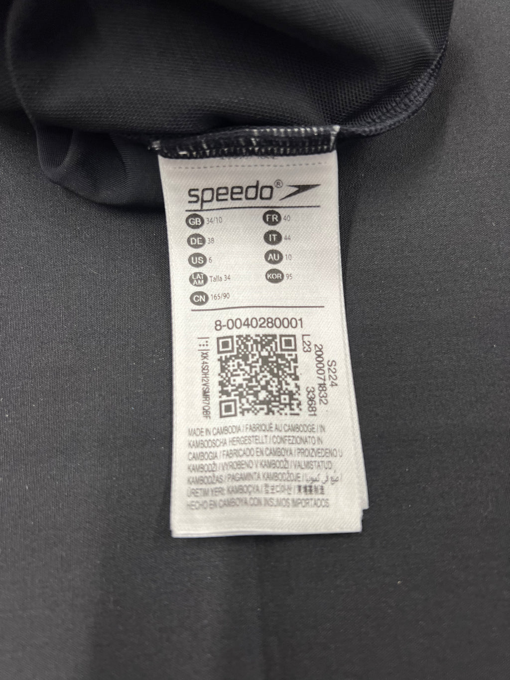 Close-up of Speedo swimsuit label showing size 10 and manufacturing details