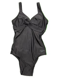 Front view of Speedo black one-piece swimsuit with twist front detail laid flat on grass