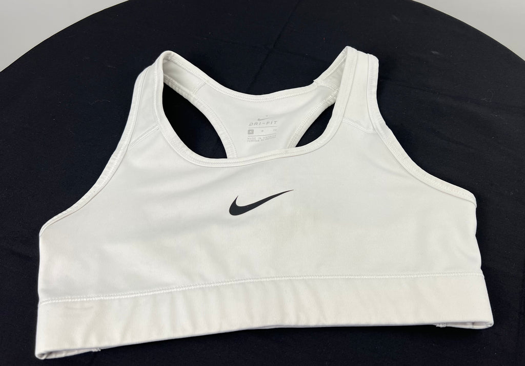 Front view of Nike white Dri-FIT sports bra top size small lying flat