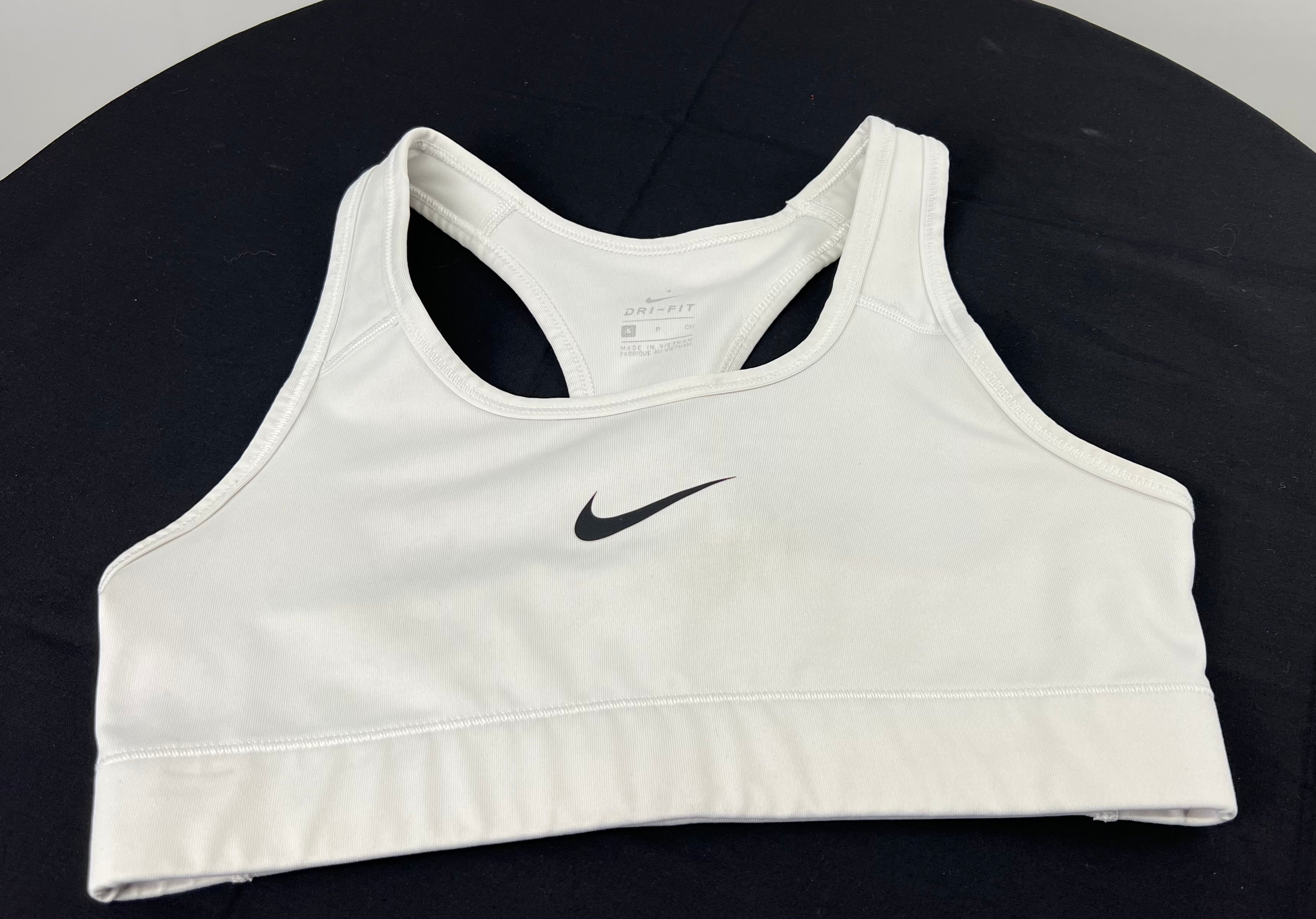 Front view of Nike white Dri-FIT sports bra top size small lying flat