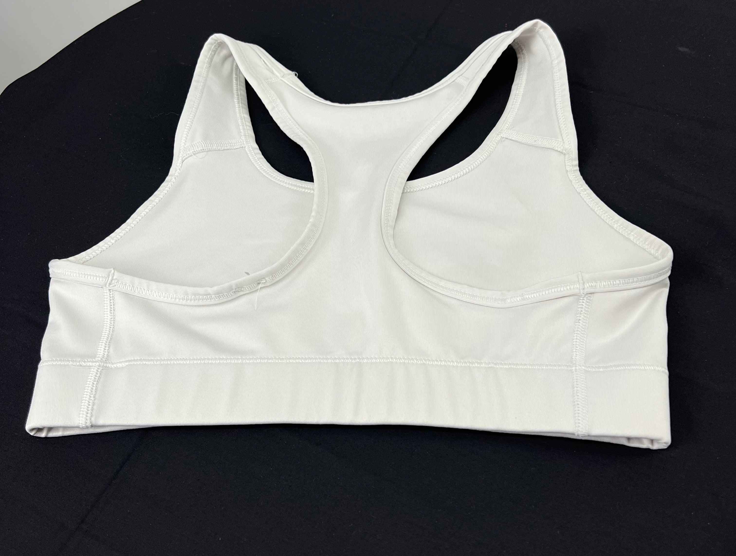 Back view of Nike white Dri-FIT sports bra showing racerback design