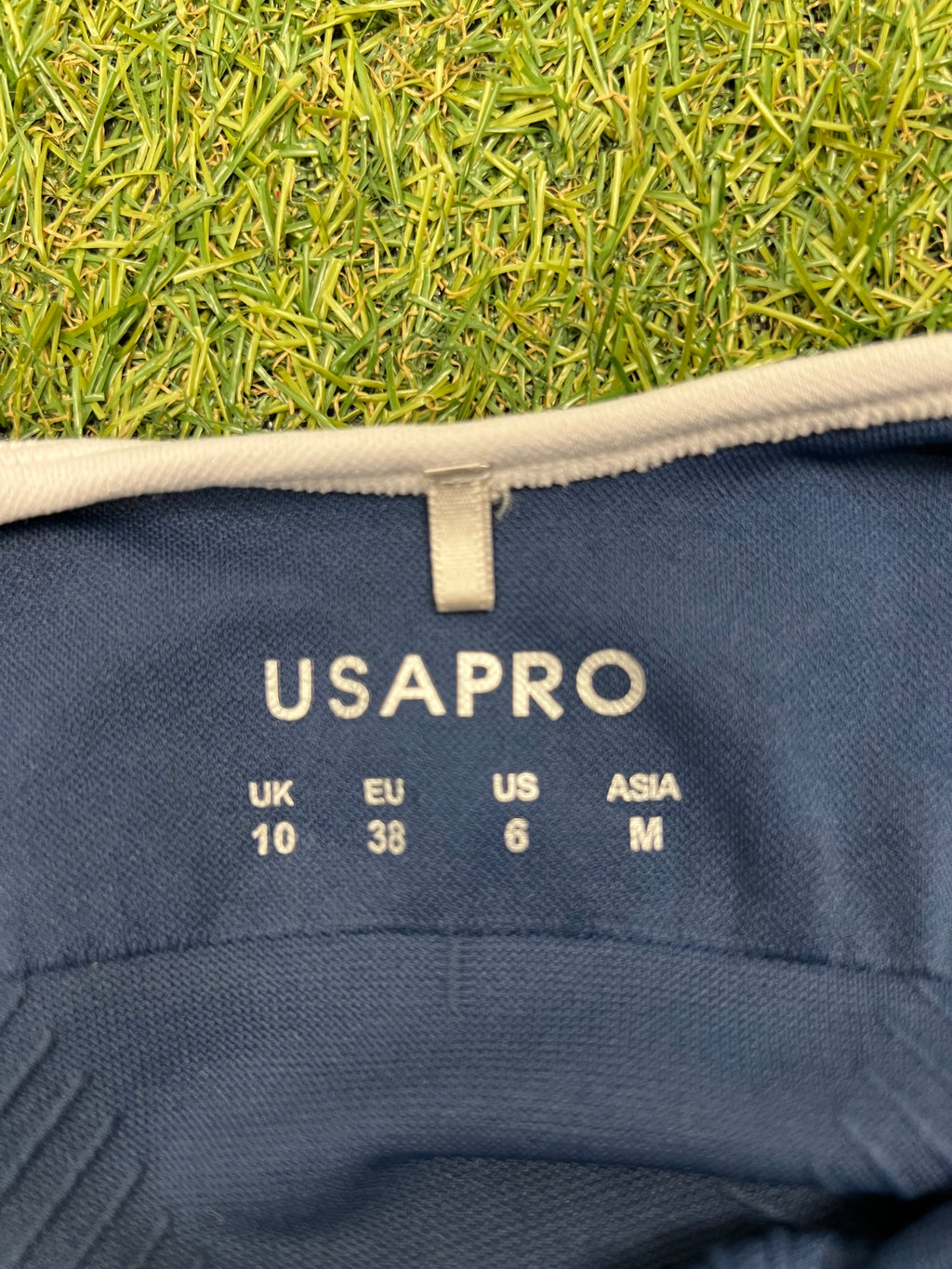 Close-up of USA Pro size label inside the blue sports bra top