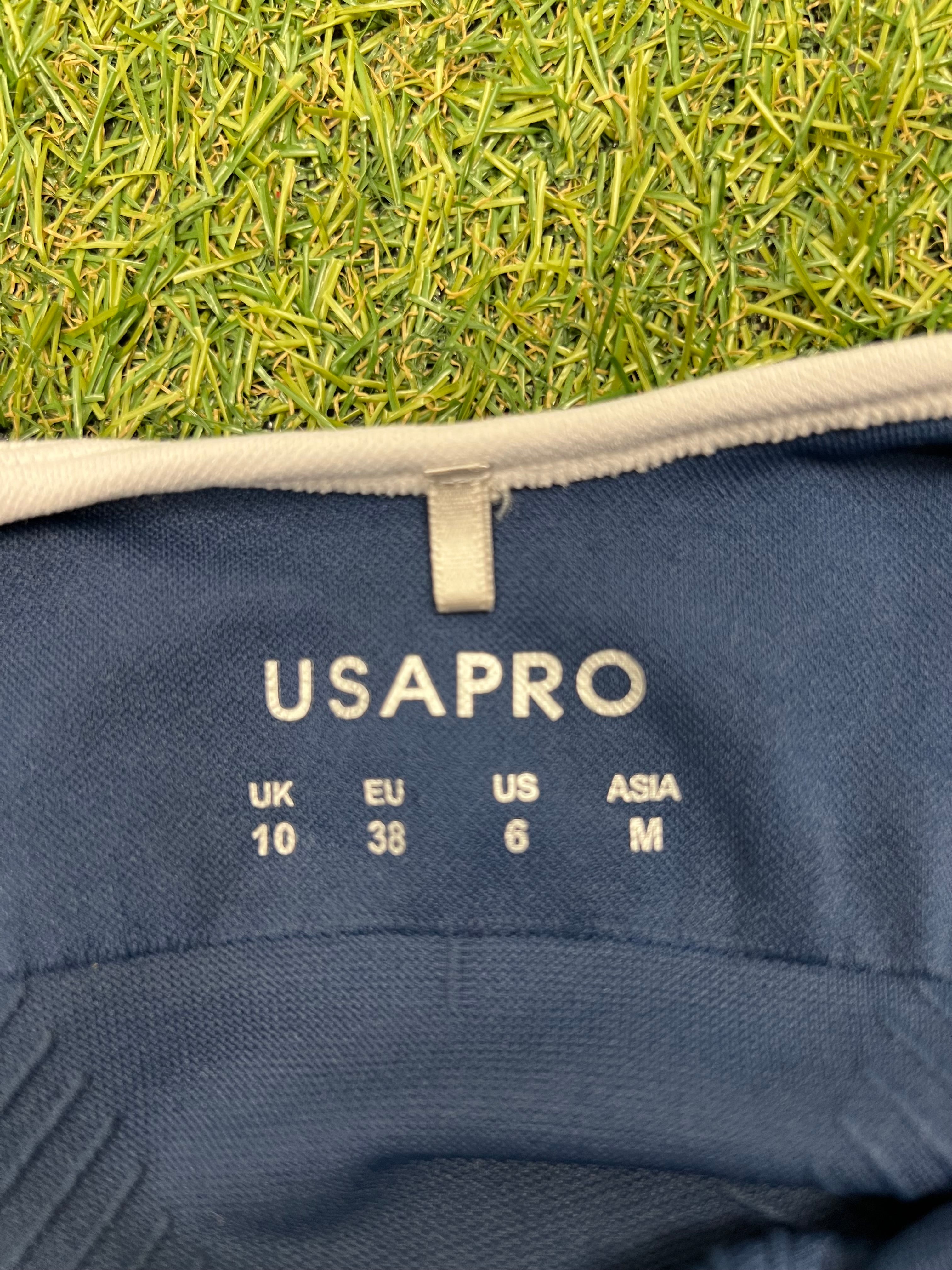 Close-up of USA Pro size label inside the blue sports bra top