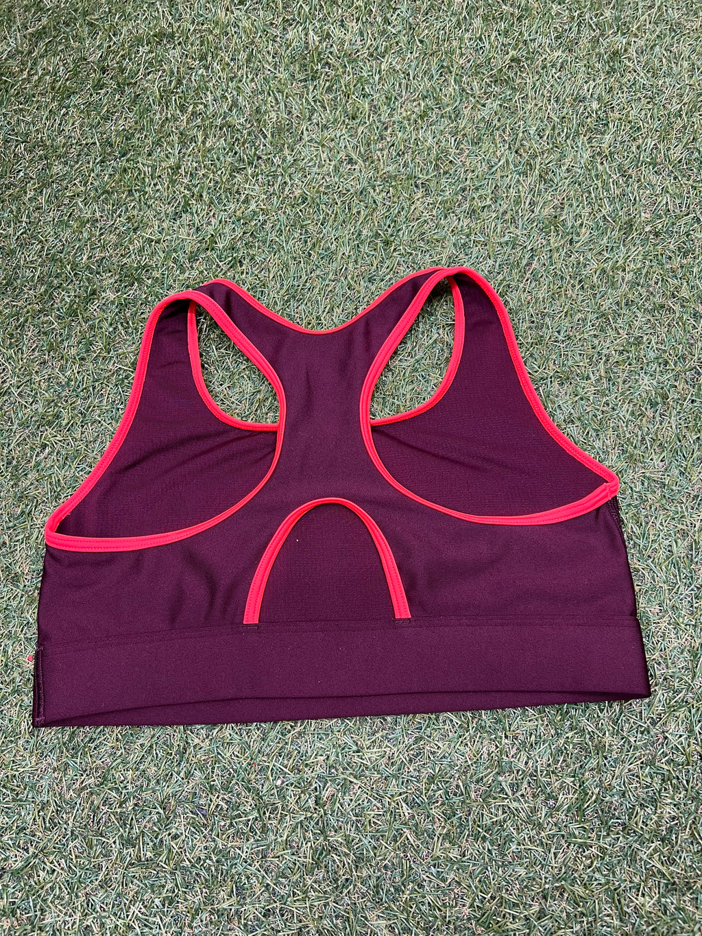 Back view of Under Armour sports bra showing racerback design and pink edging