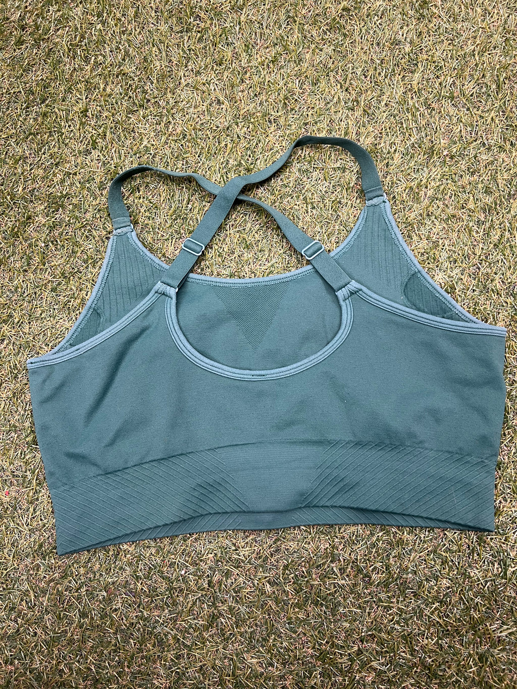 Back view of USA Pro green sports bra top showing crossed adjustable straps