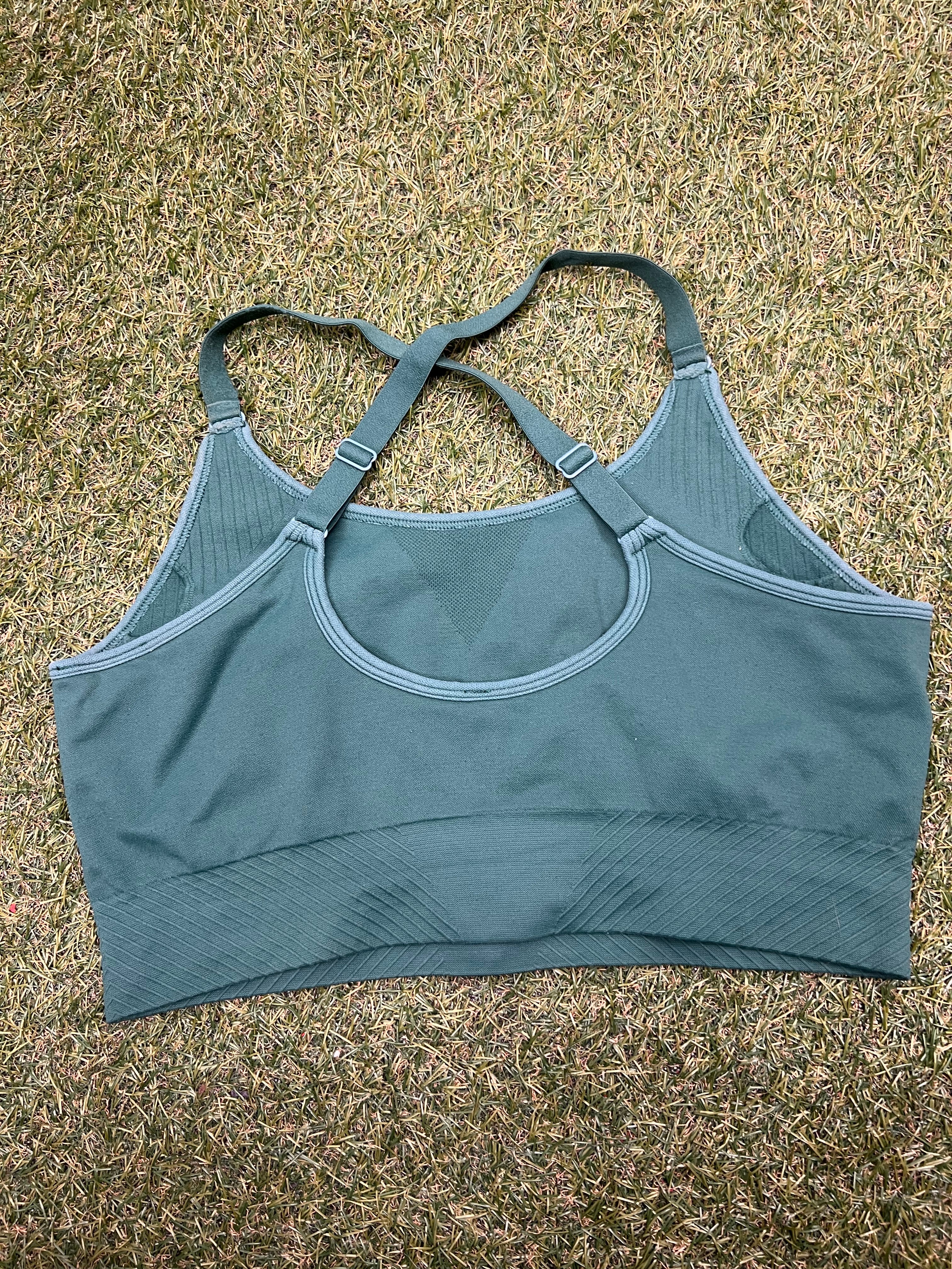 Back view of USA Pro green sports bra top showing crossed adjustable straps