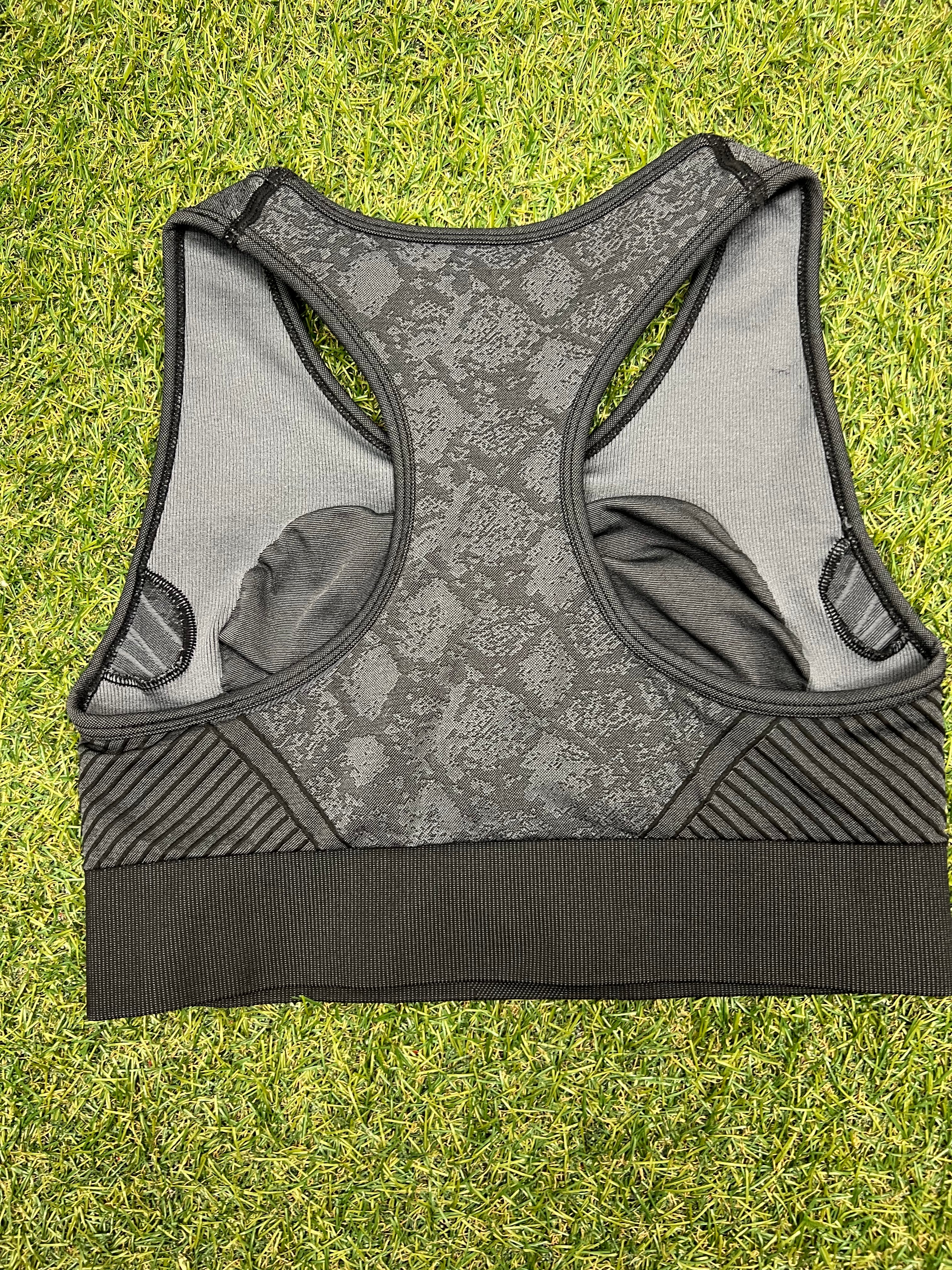 Back view of racerback USA Pro sports bra showing inner lining and striped side panels