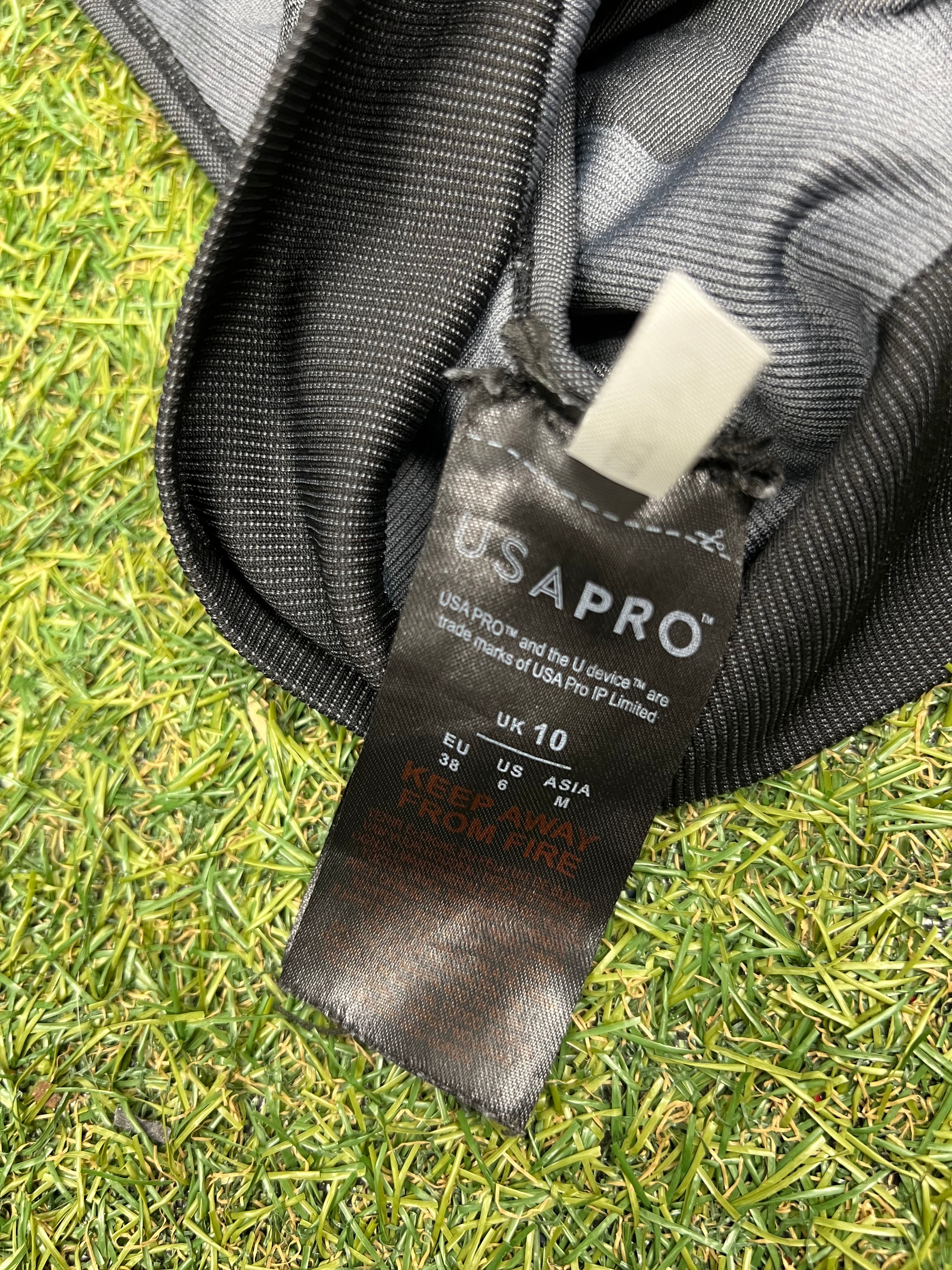 Close-up of USA Pro black care label inside sports bra with size UK 10 details